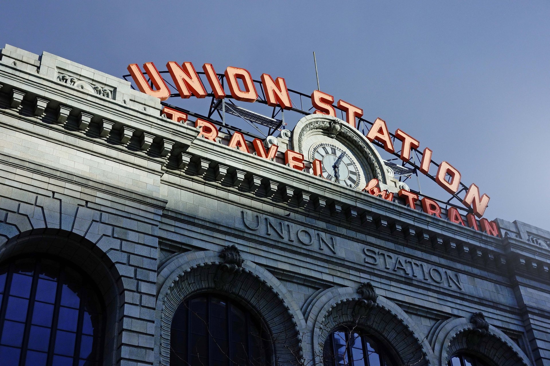the union station sign has a clock on it