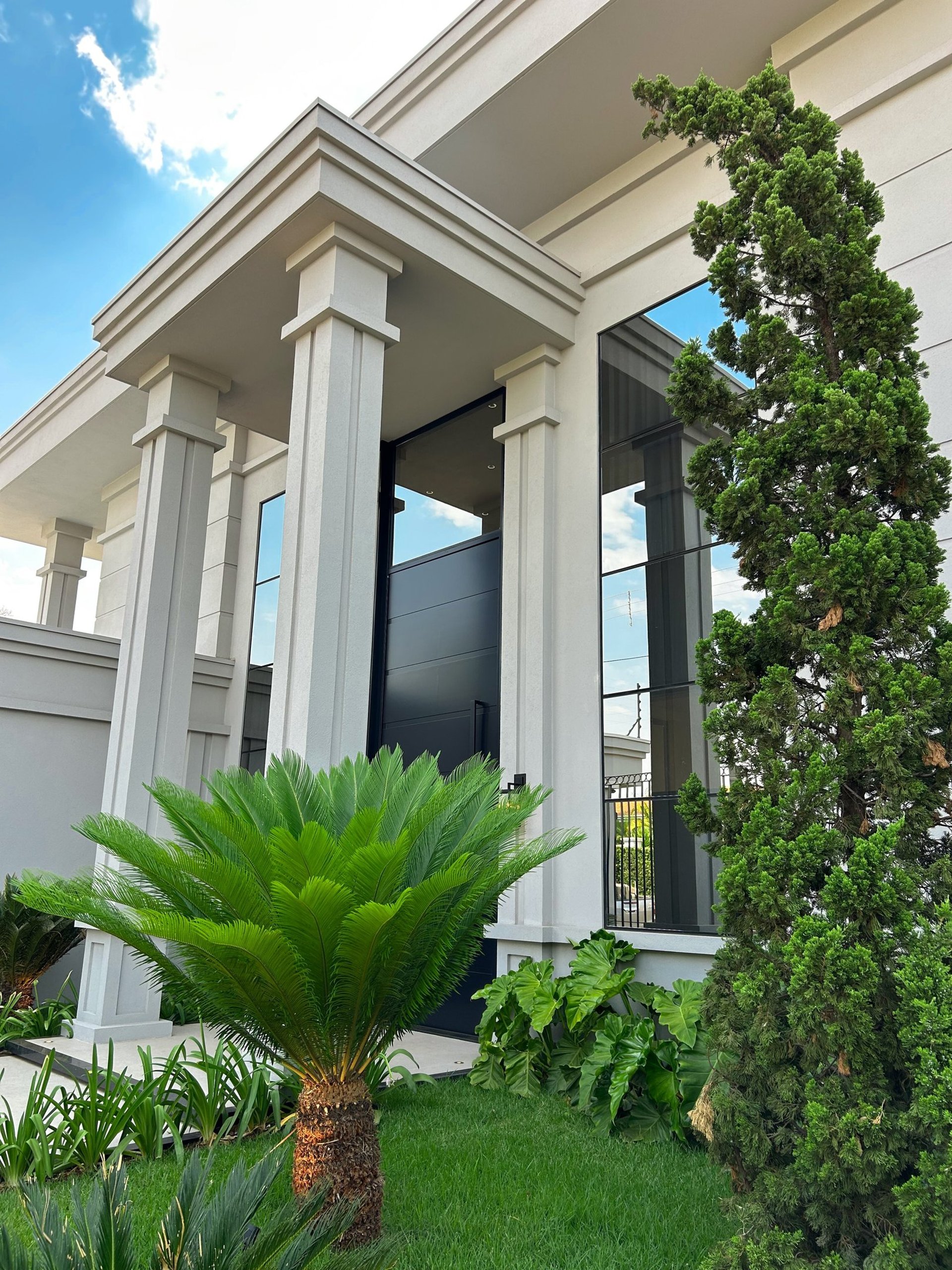 an abstract photo of a curved building with a blue sky in the background