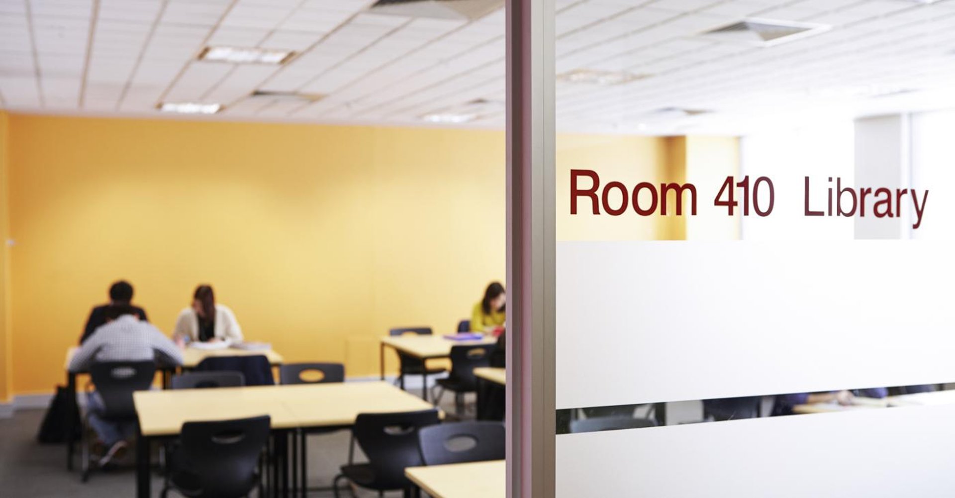 a woman in a blue cardigan pointing to the side