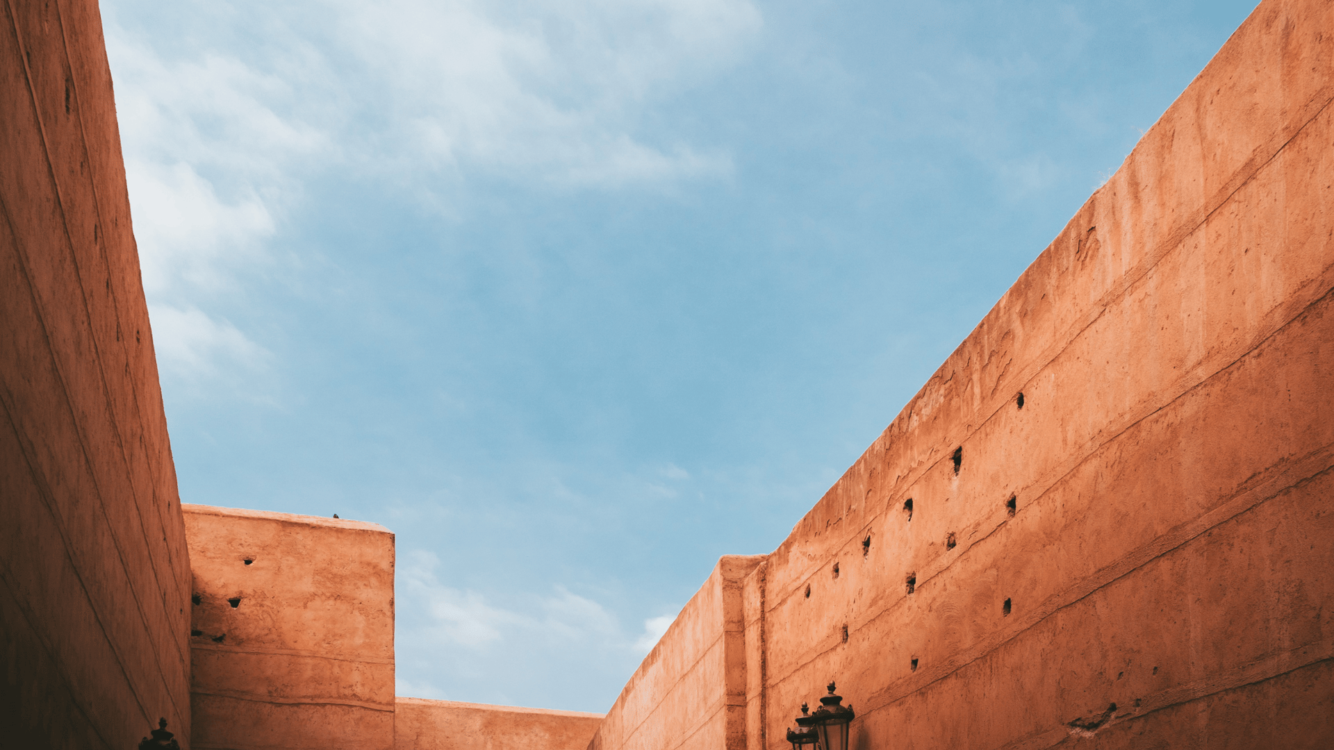 an abstract photo of a curved building with a blue sky in the background