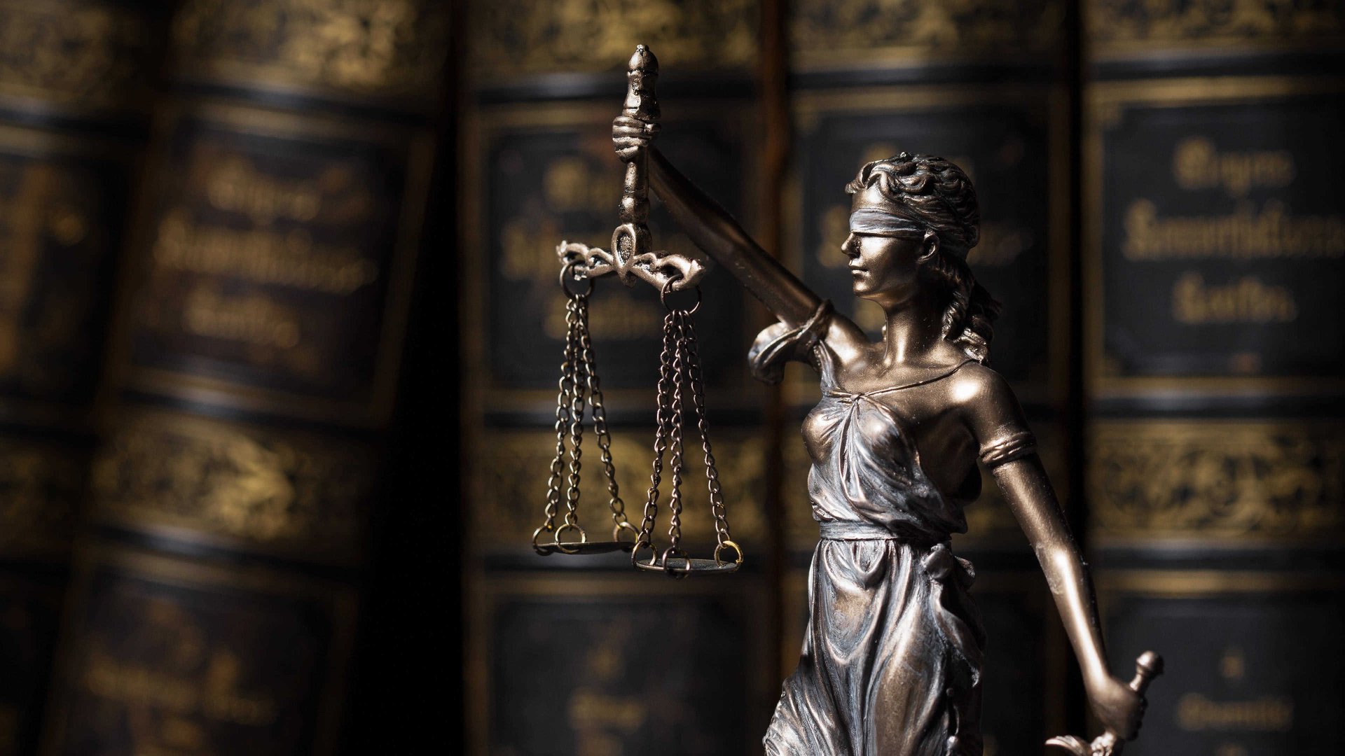 a statue of a lady justice holding a scale