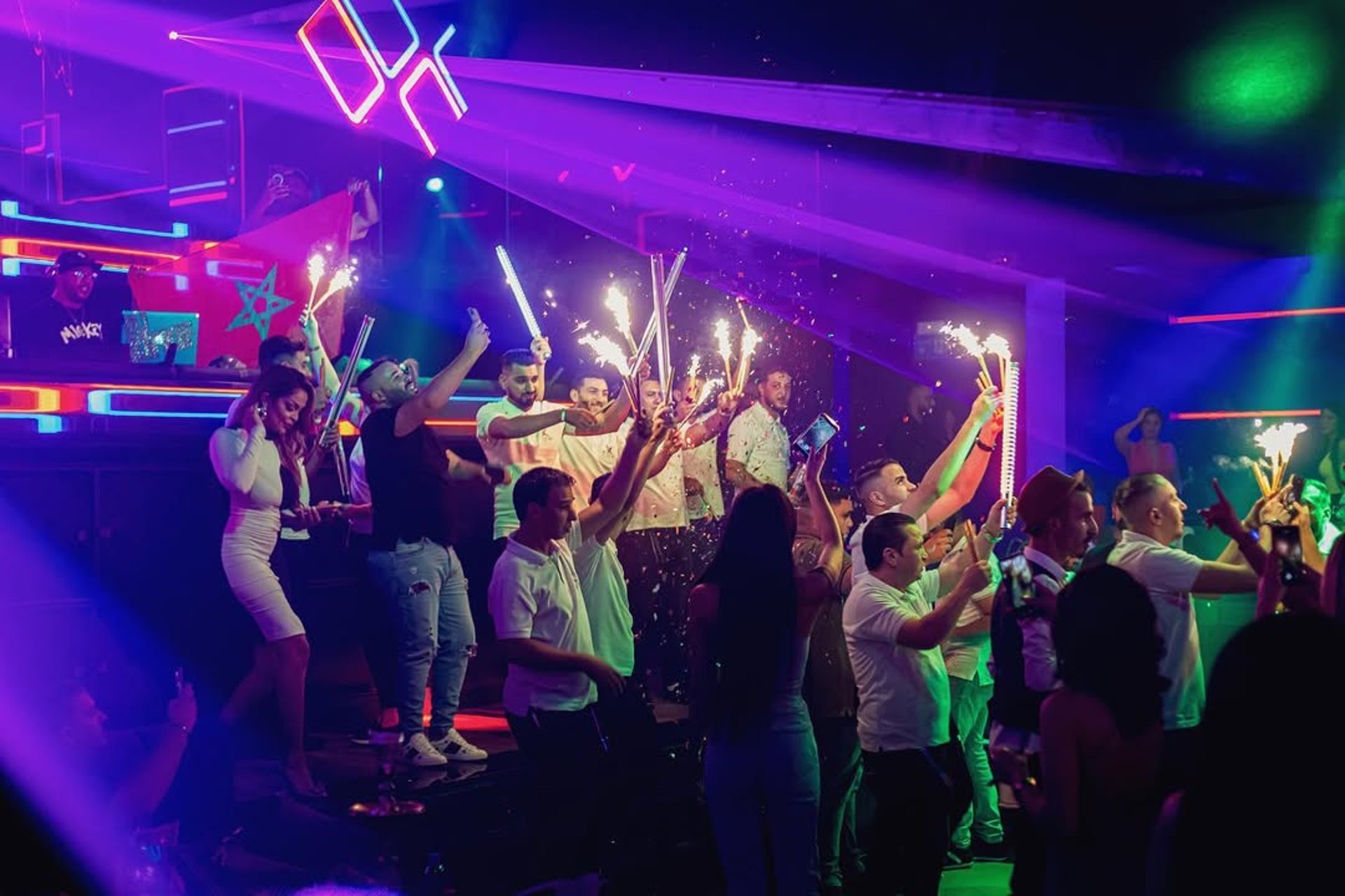 people performing on stage near partying people