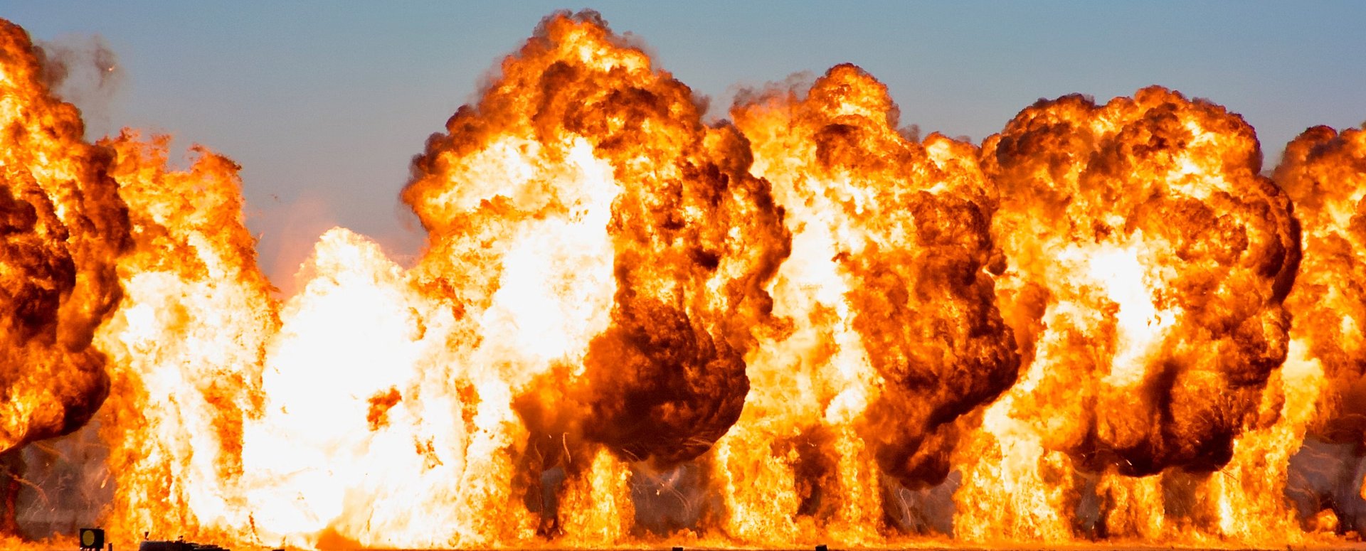 brown and white smoke on brown rock formation