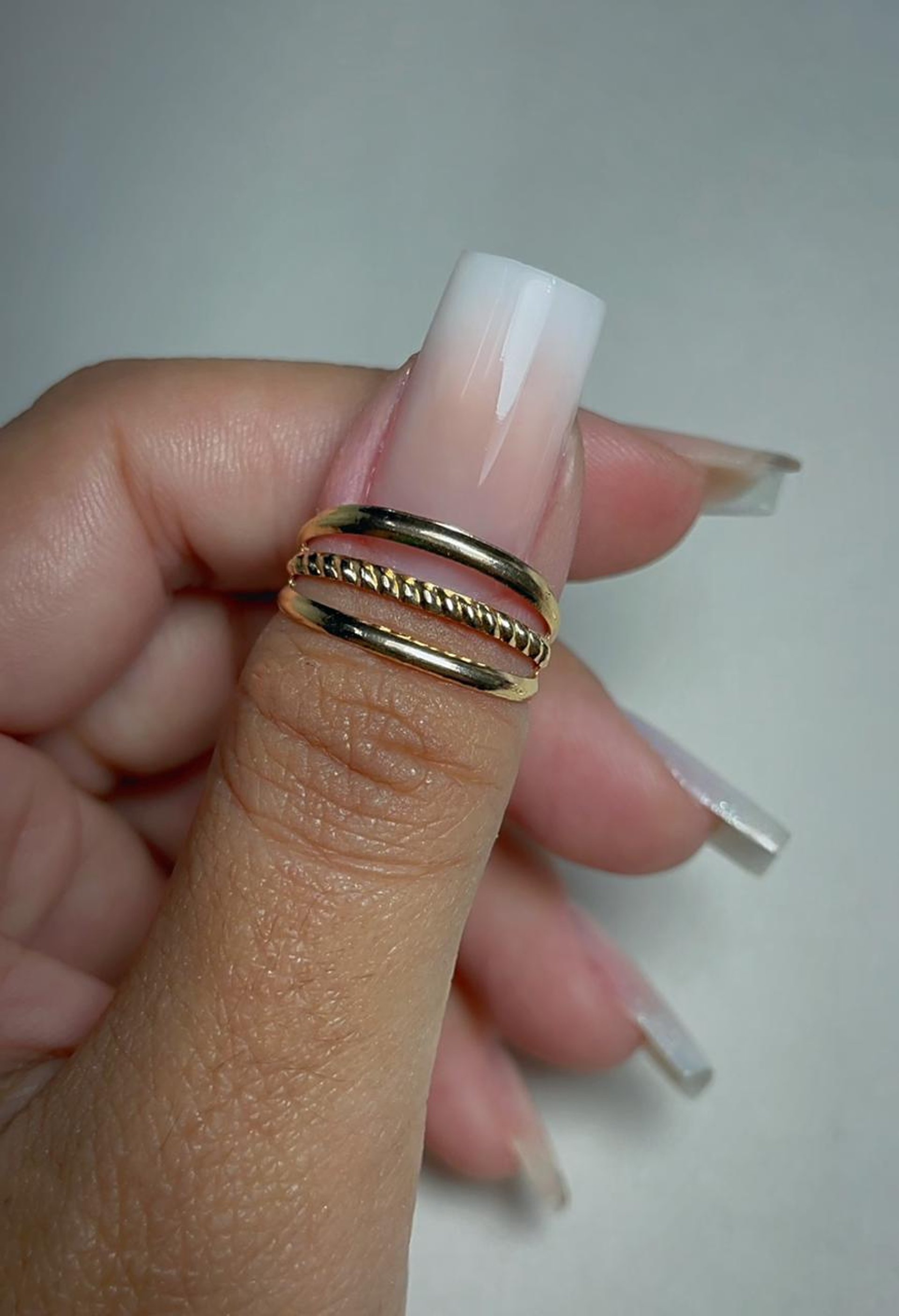 person wearing silver ring on left ring finger