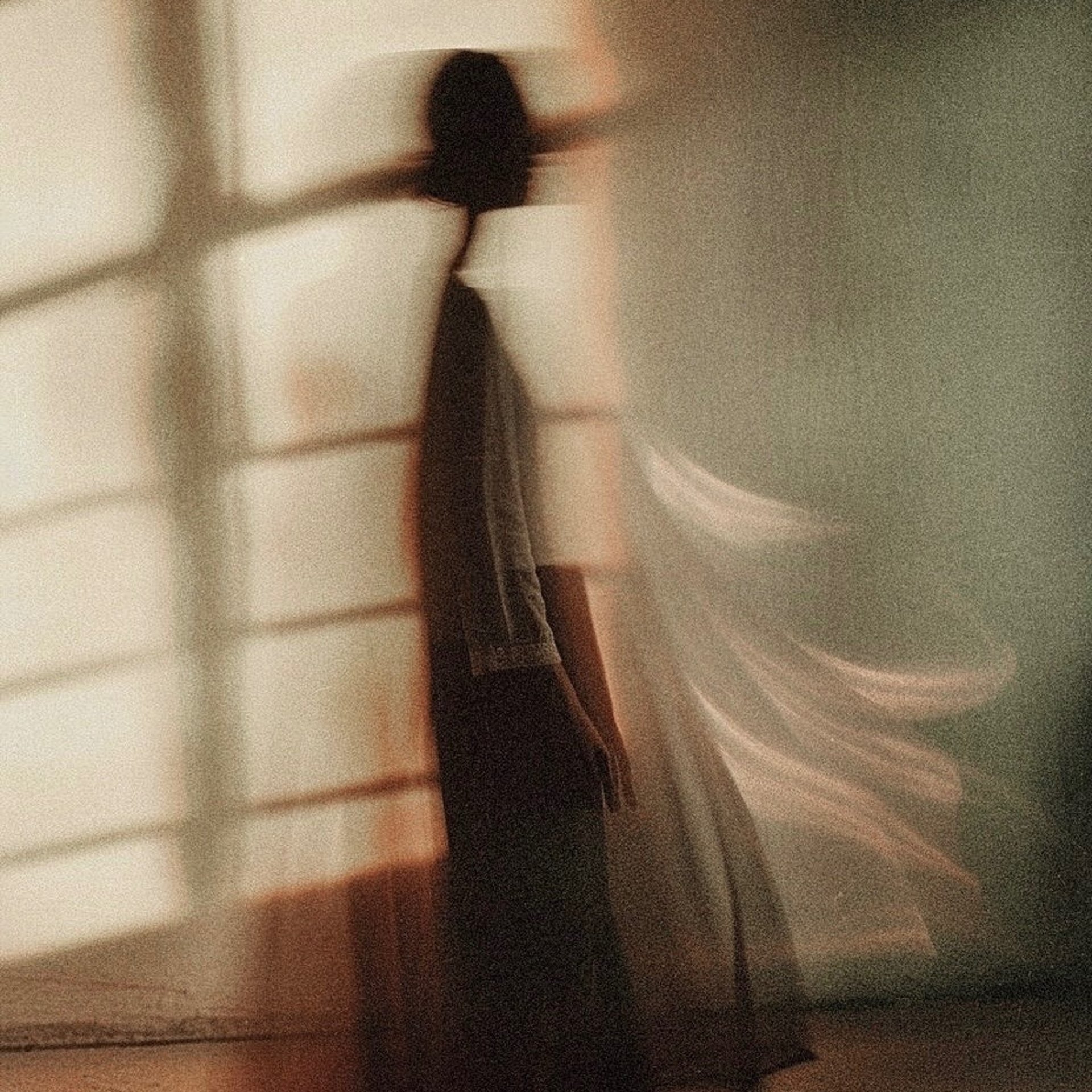 an abstract photo of a curved building with a blue sky in the background