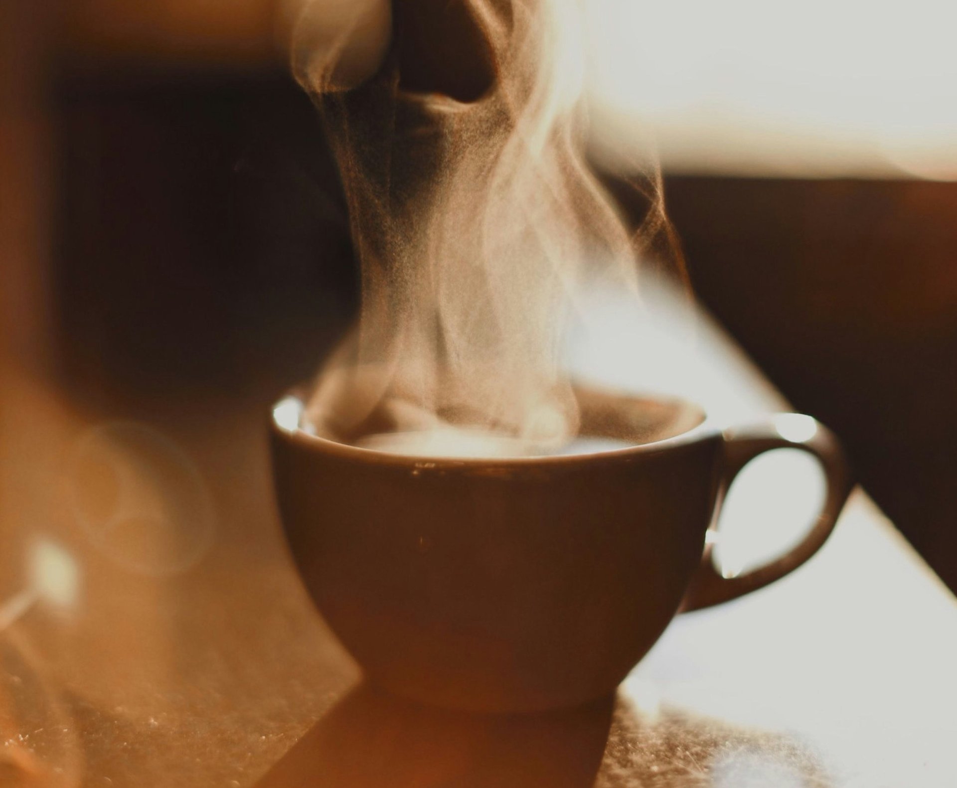 brown ceramic cup with white smoke