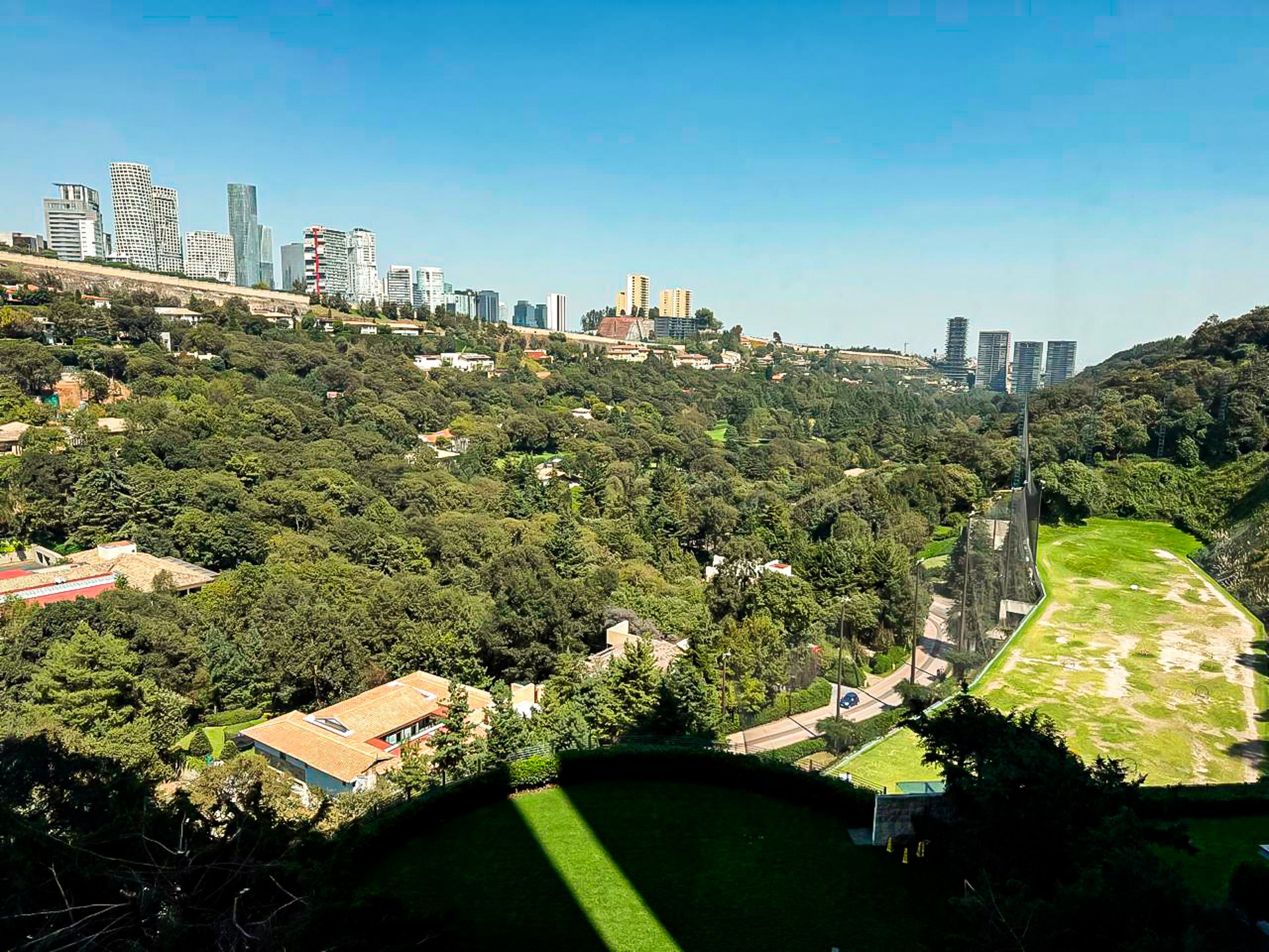 an abstract photo of a curved building with a blue sky in the background