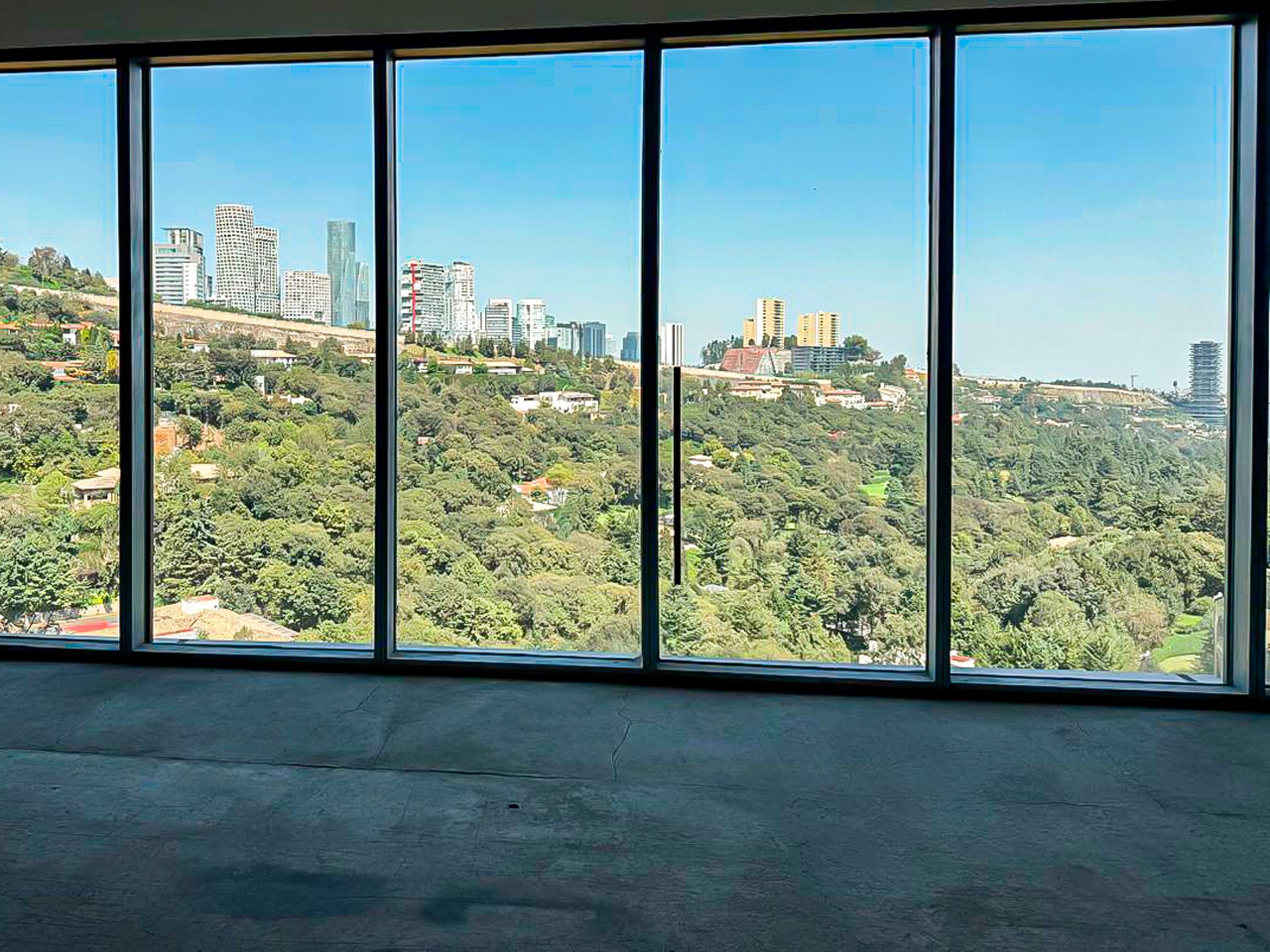 an abstract photo of a curved building with a blue sky in the background