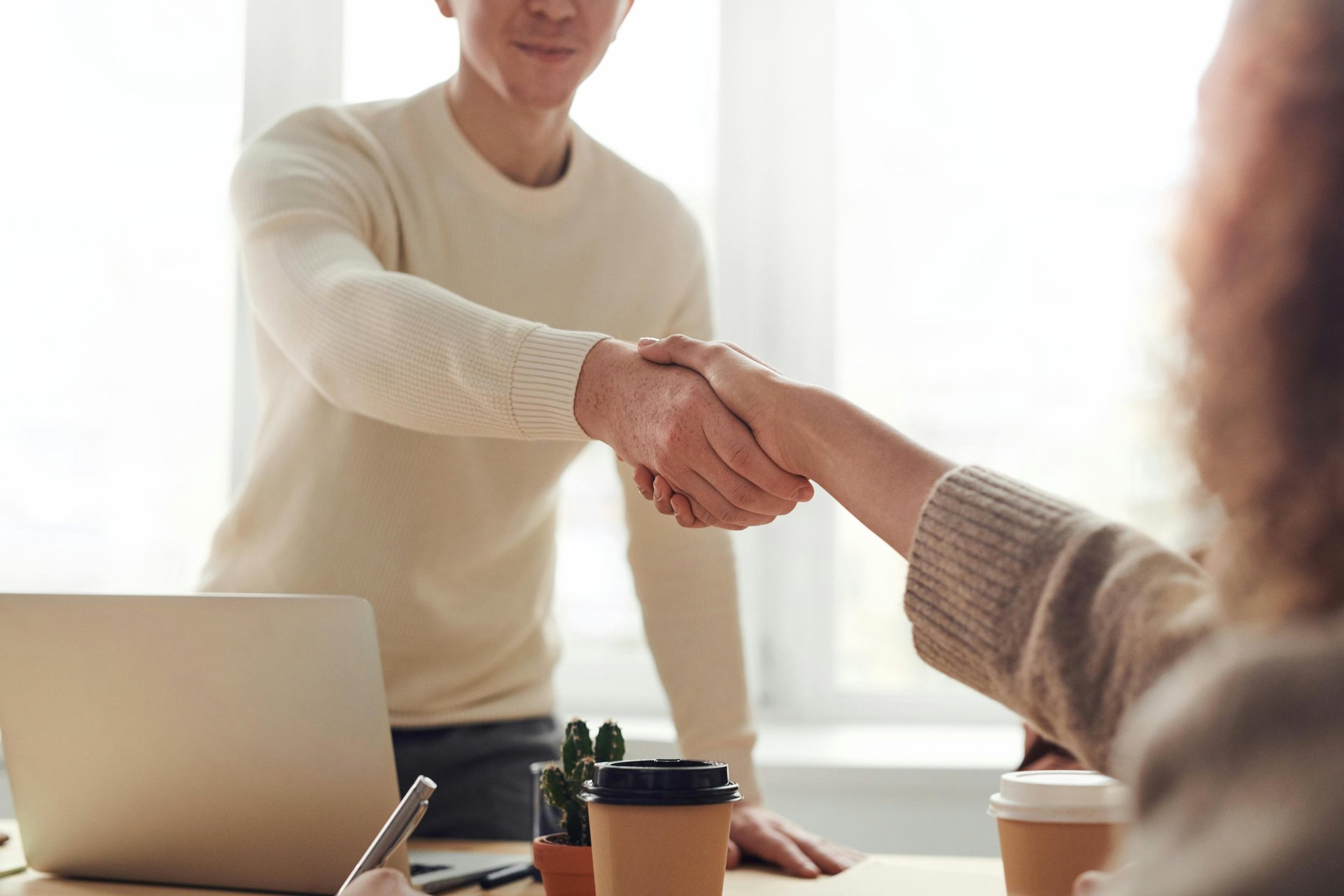 people shaking hands in an office