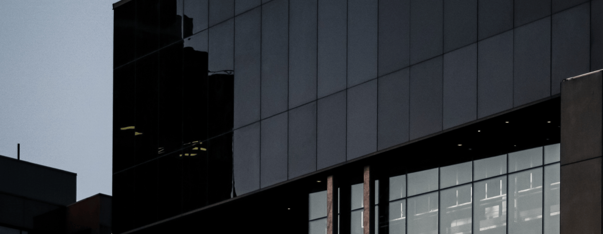 an abstract photo of a curved building with a blue sky in the background