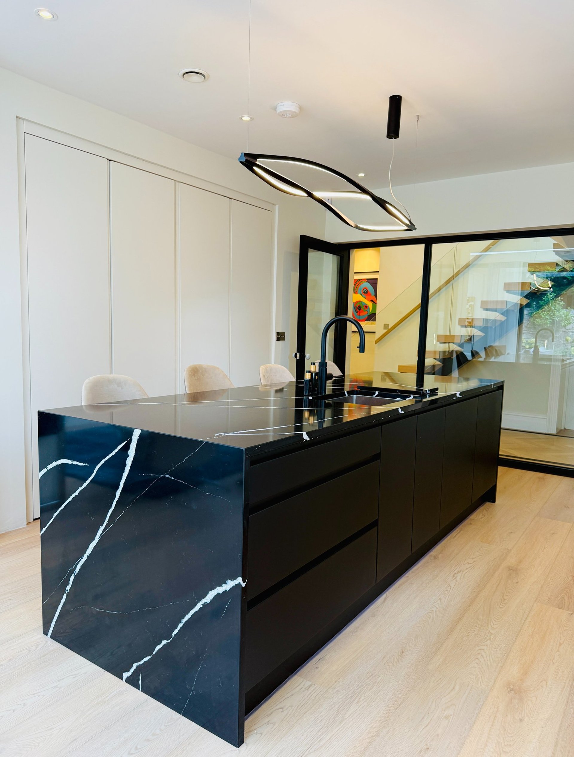 an abstract photo of a curved building with a blue sky in the background