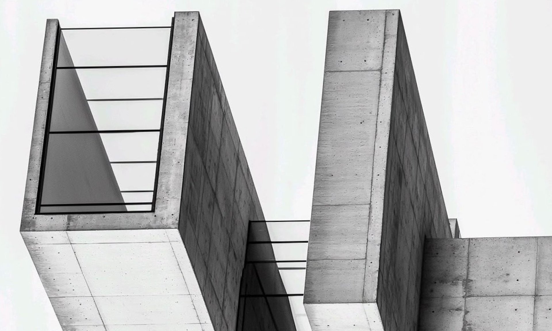 an abstract photo of a curved building with a blue sky in the background