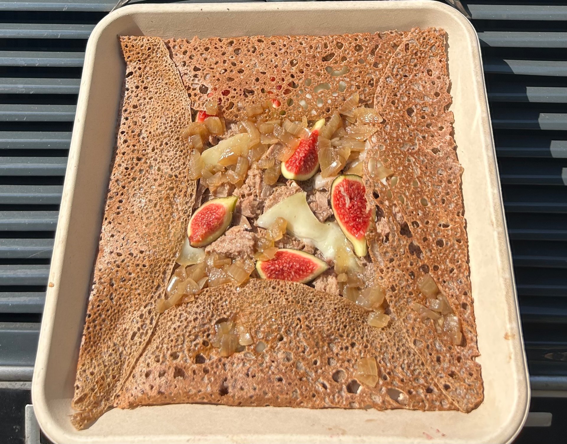 an abstract photo of a curved building with a blue sky in the background