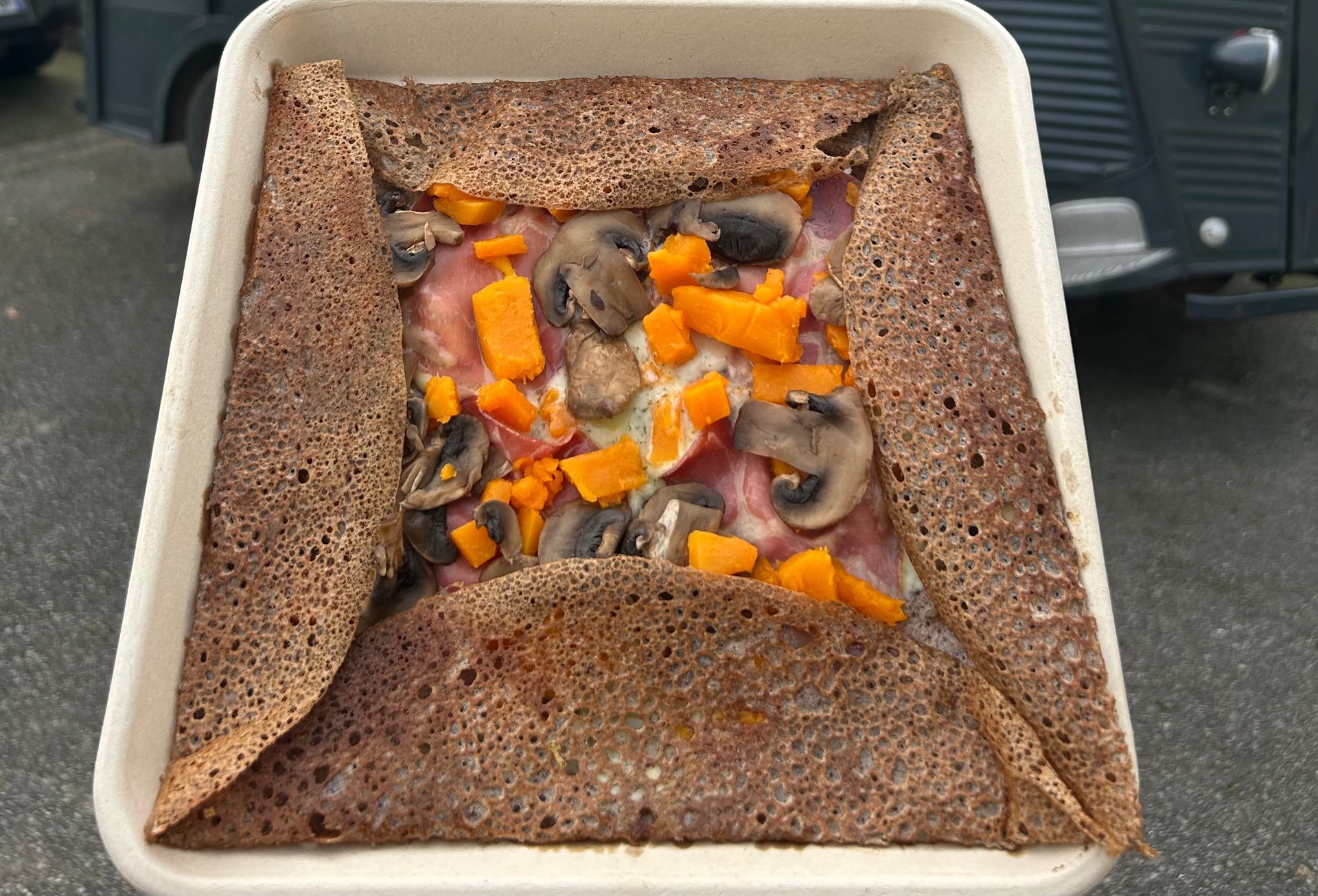 an abstract photo of a curved building with a blue sky in the background