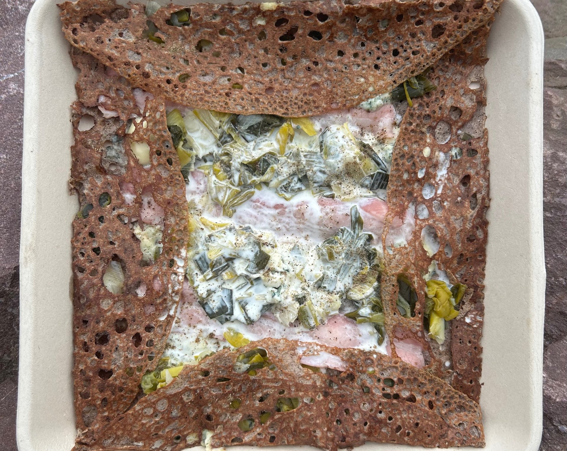 an abstract photo of a curved building with a blue sky in the background