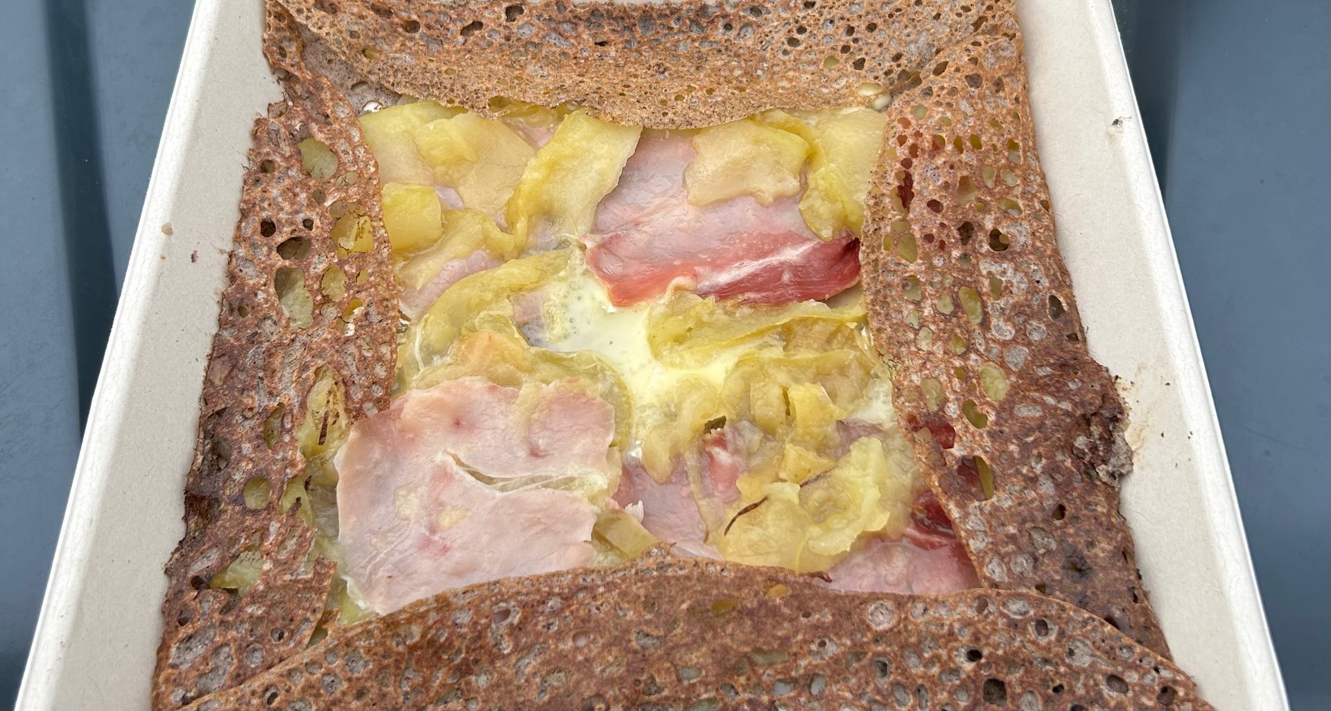 an abstract photo of a curved building with a blue sky in the background