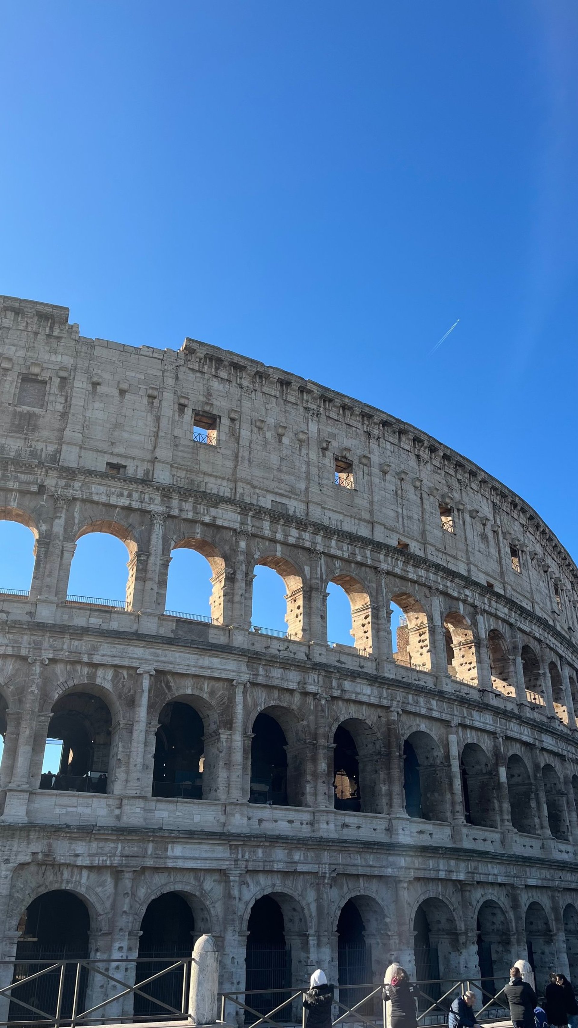 an abstract photo of a curved building with a blue sky in the background