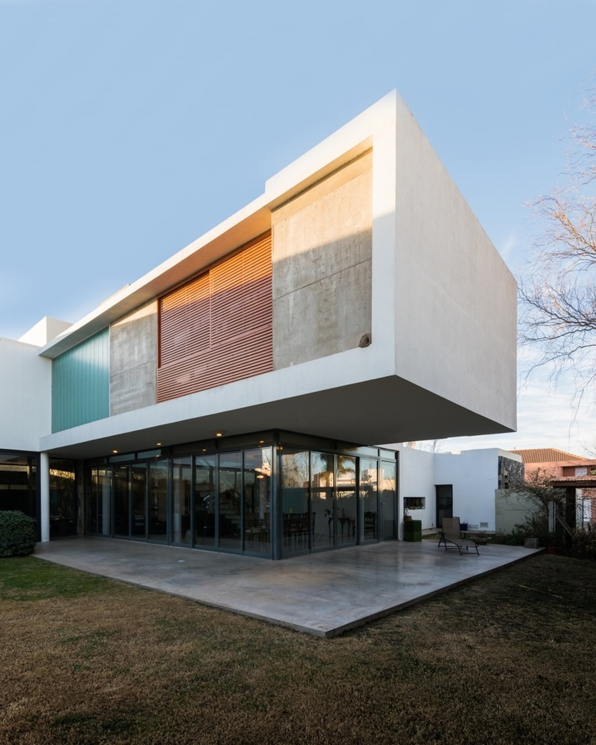 an abstract photo of a curved building with a blue sky in the background