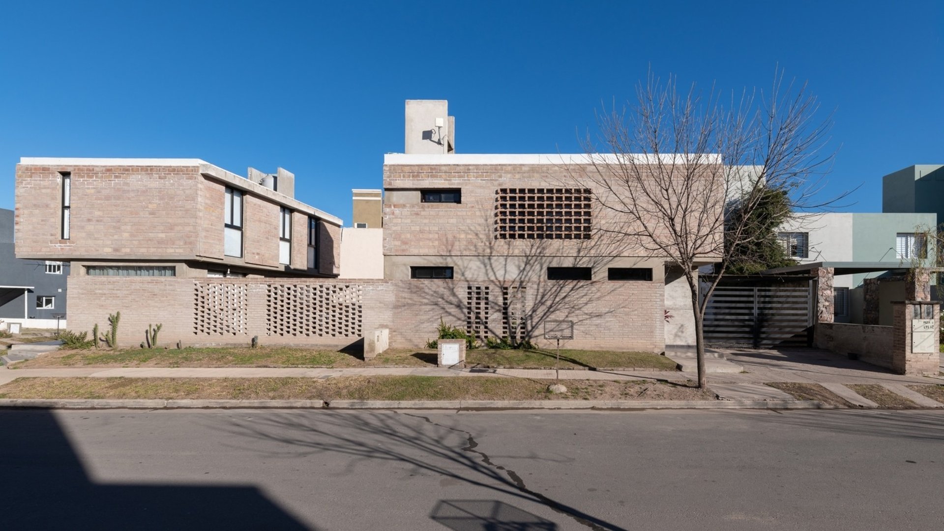 an abstract photo of a curved building with a blue sky in the background