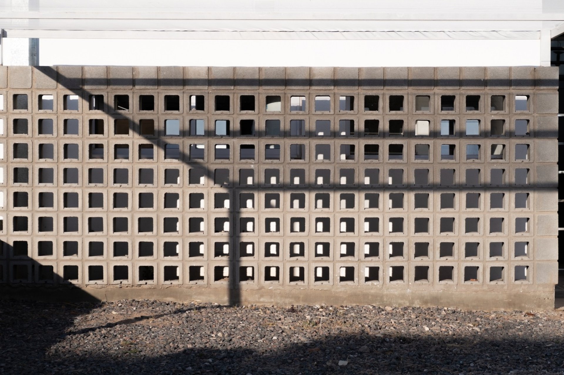 an abstract photo of a curved building with a blue sky in the background