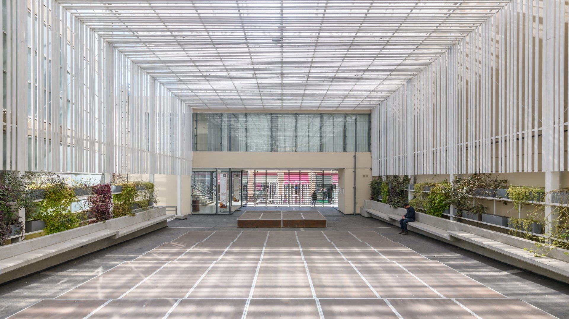 an abstract photo of a curved building with a blue sky in the background