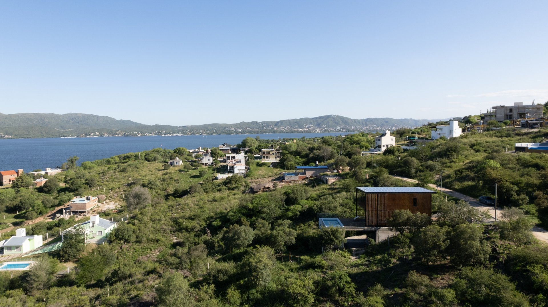 an abstract photo of a curved building with a blue sky in the background