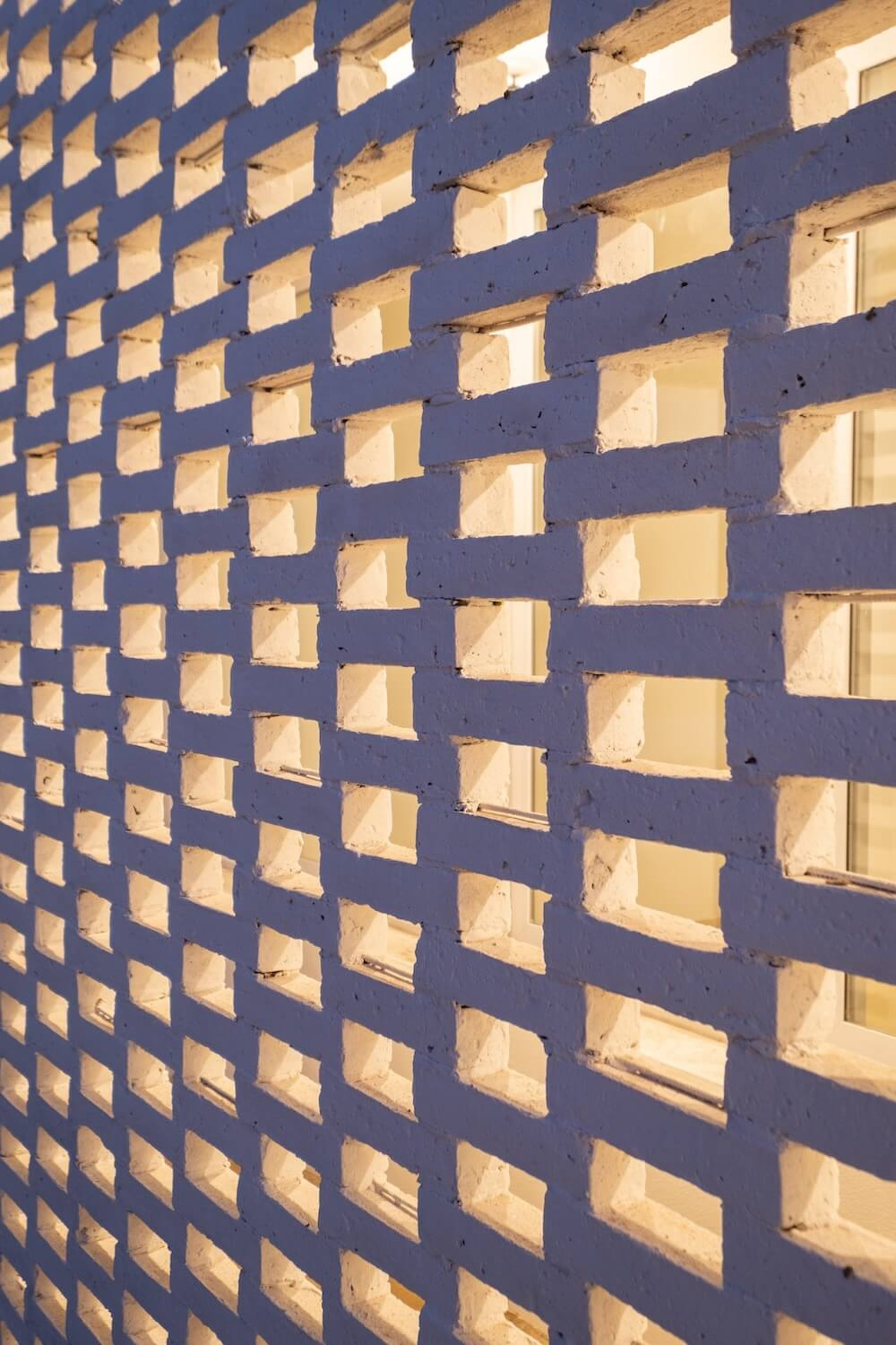 an abstract photo of a curved building with a blue sky in the background