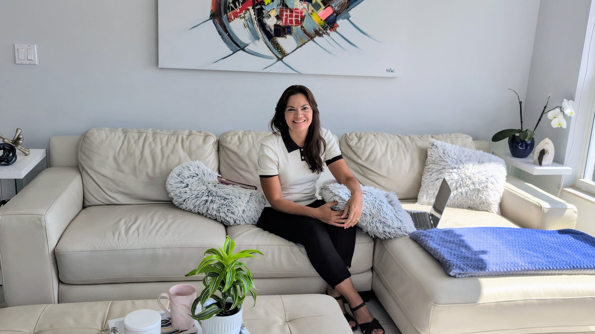 woman in gray sweater sitting on white chair
