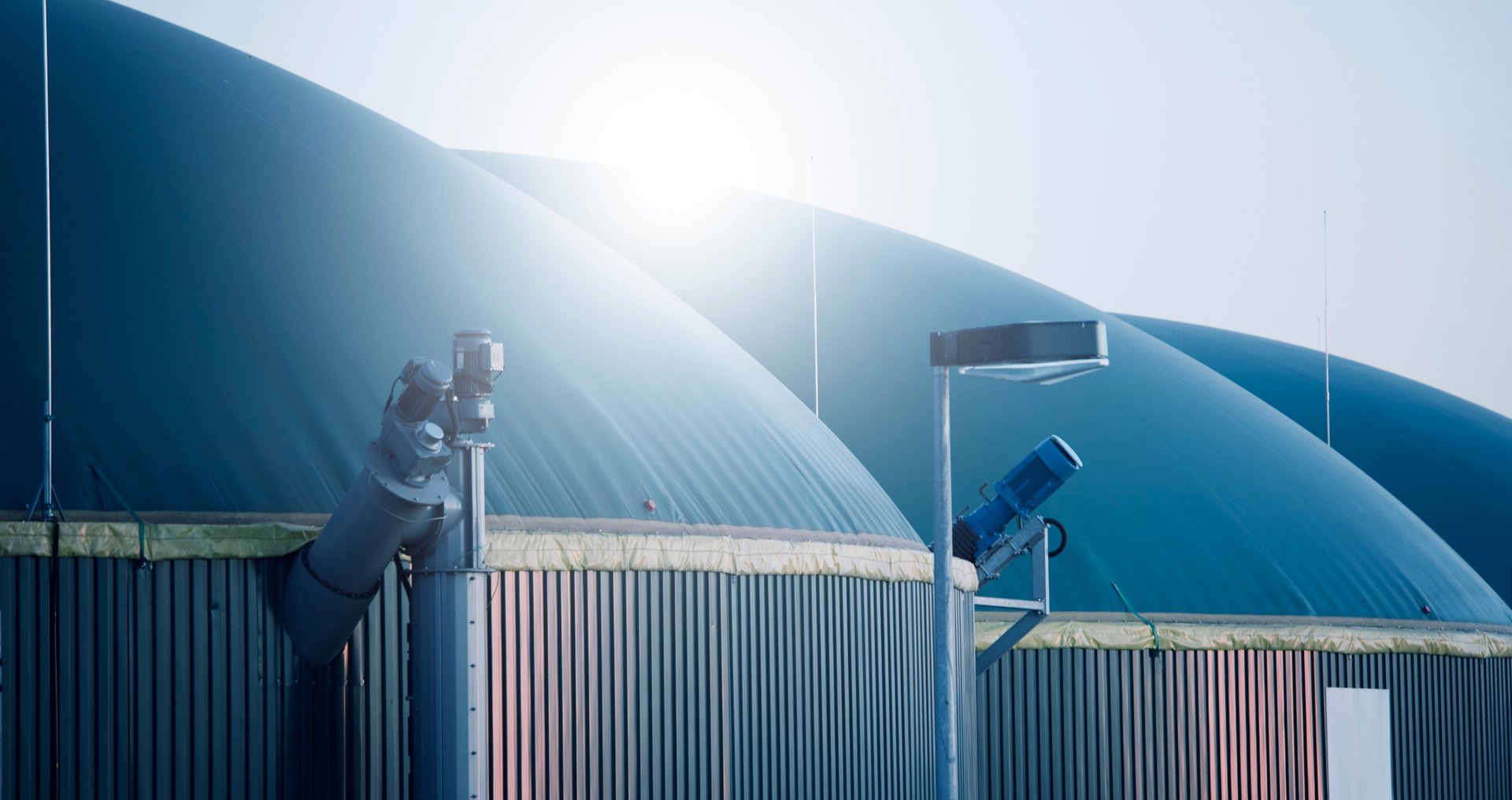 a row of green gas pumps at night