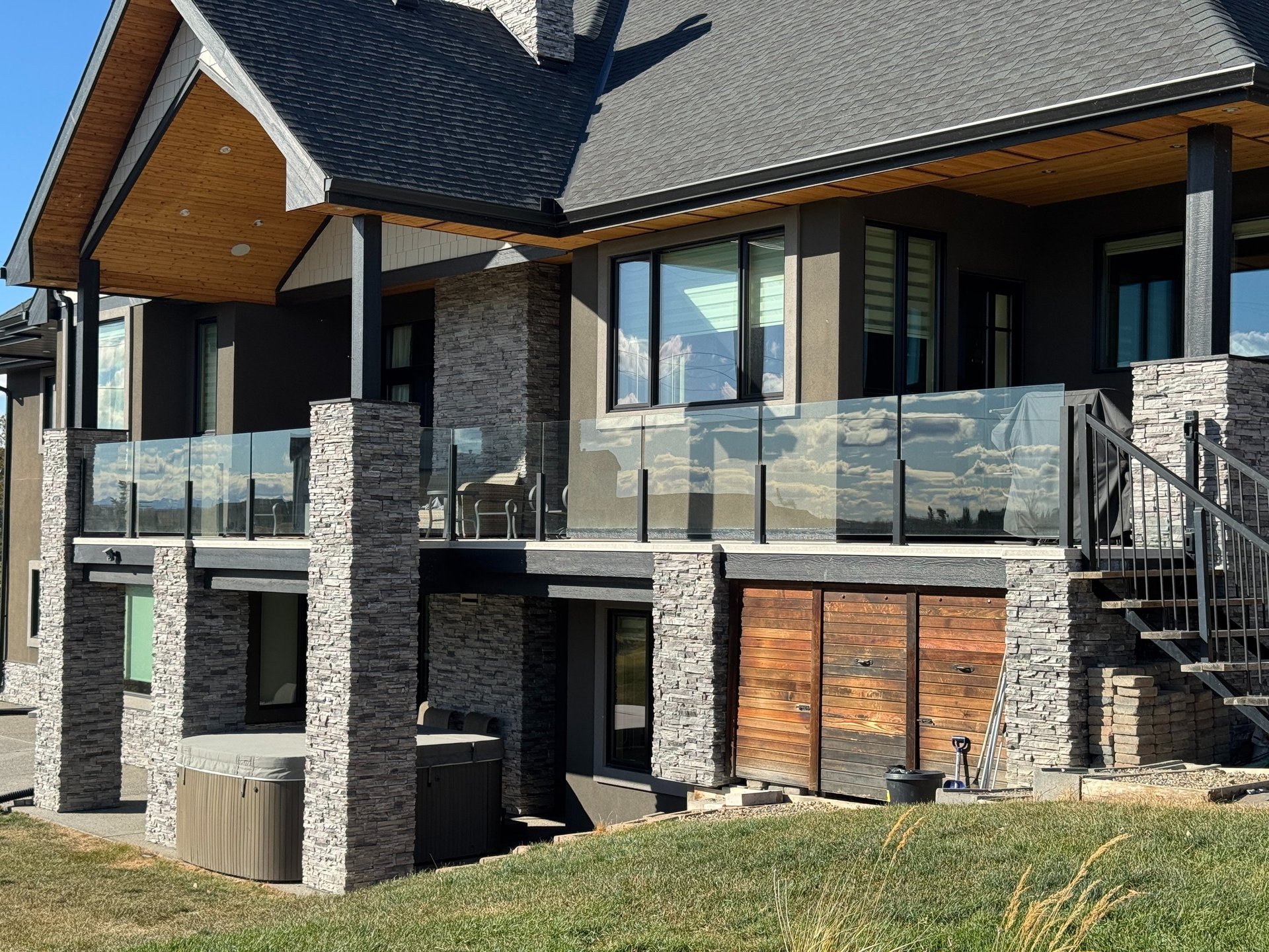A dog standing on a deck with leaves on the ground