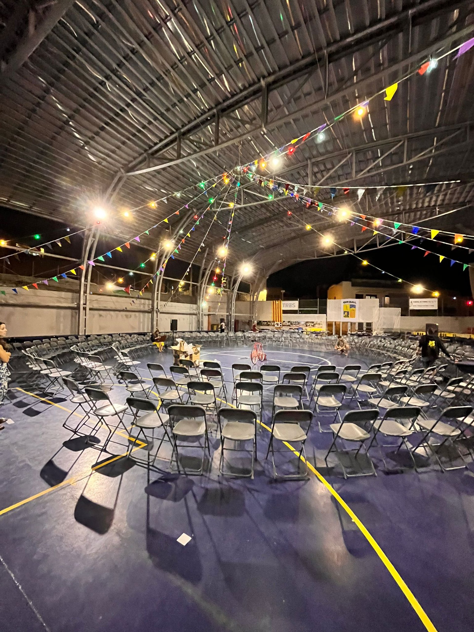 person picking white and red book on bookshelf