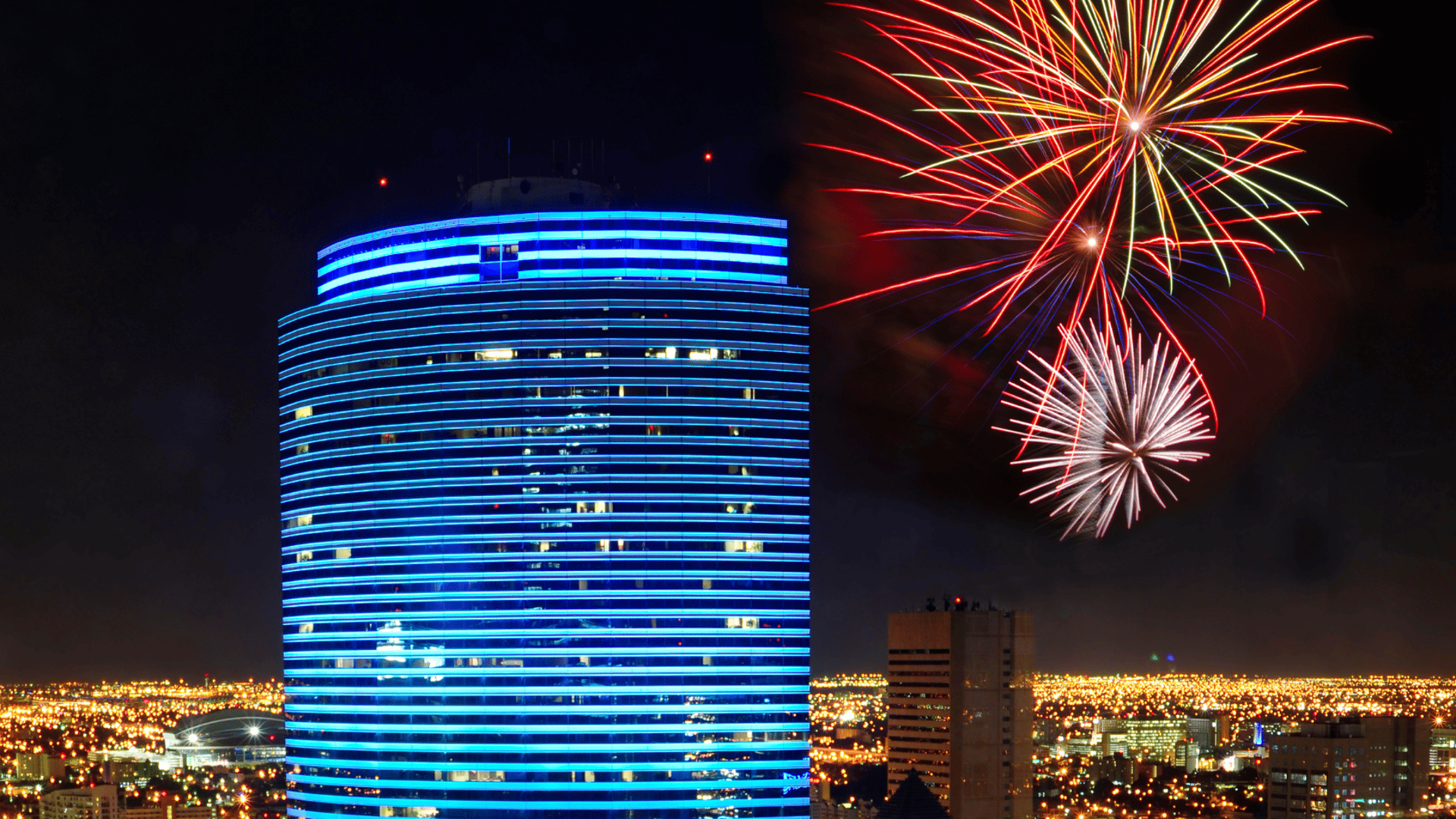 fireworks display over city buildings during night time