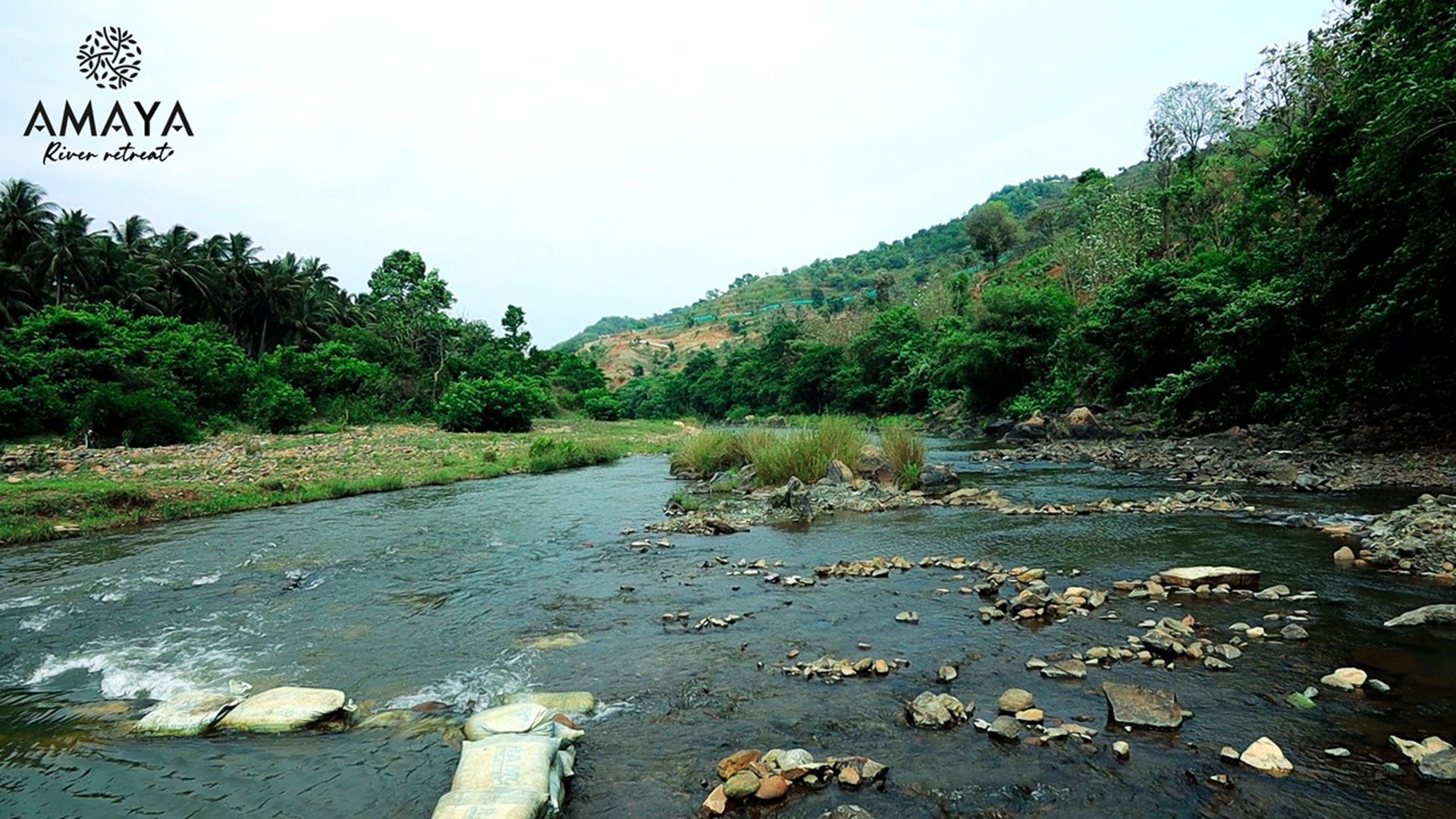a river with rocks and rocks in the foreground