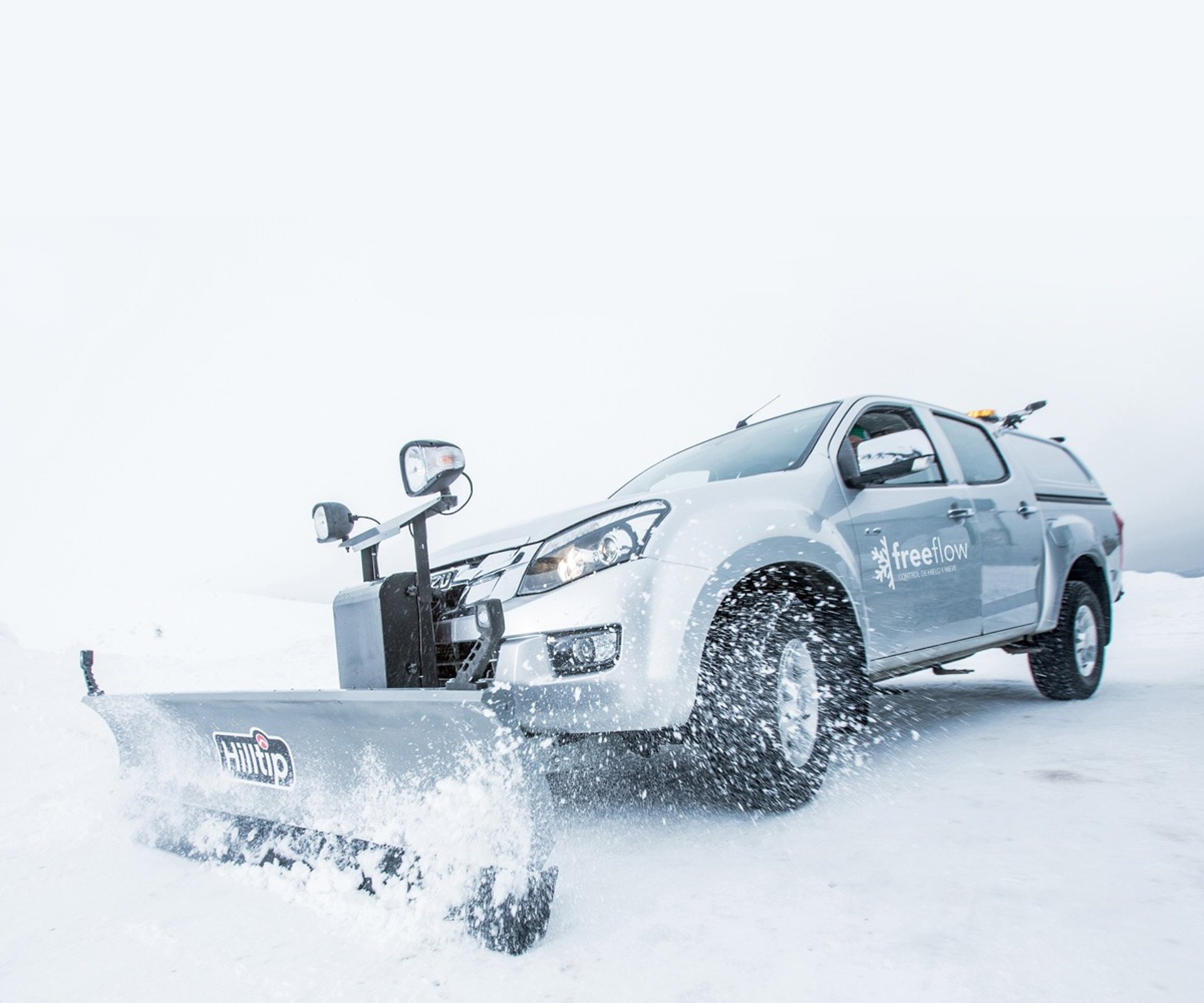 a snow covered road in the middle of a forest