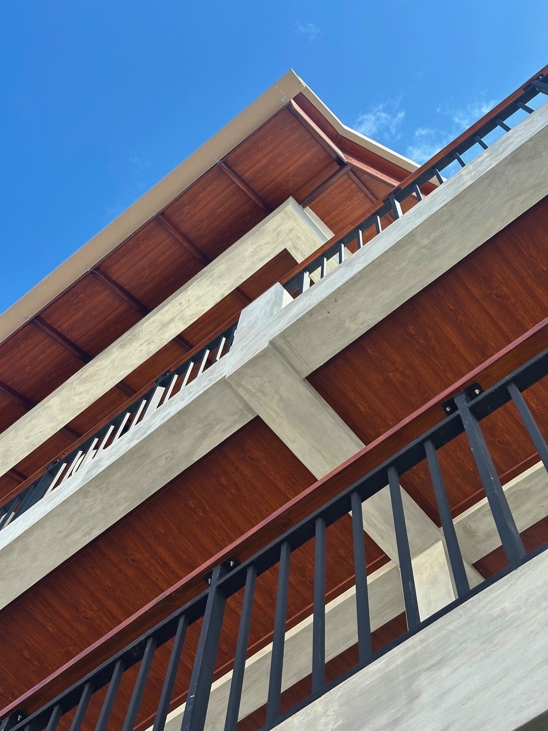 an abstract photo of a curved building with a blue sky in the background