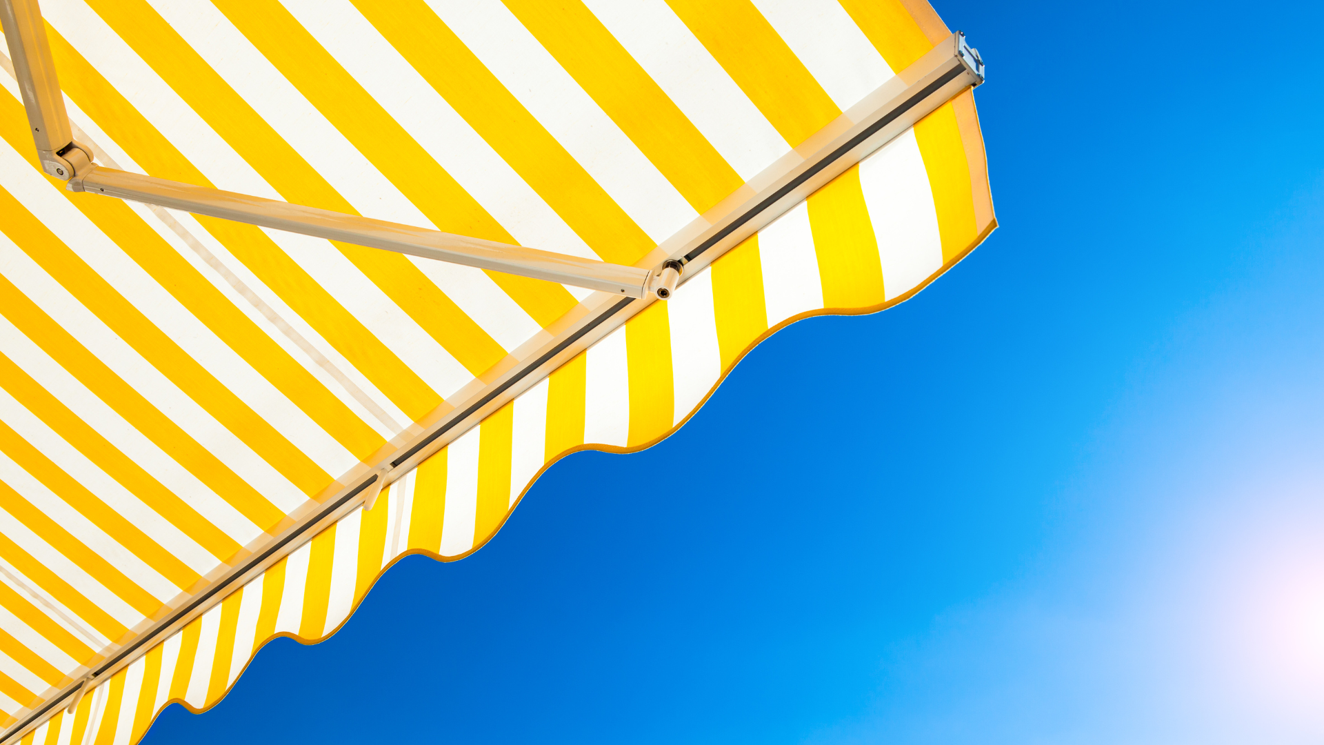 white and teal striped umbrella under blue sky during daytime