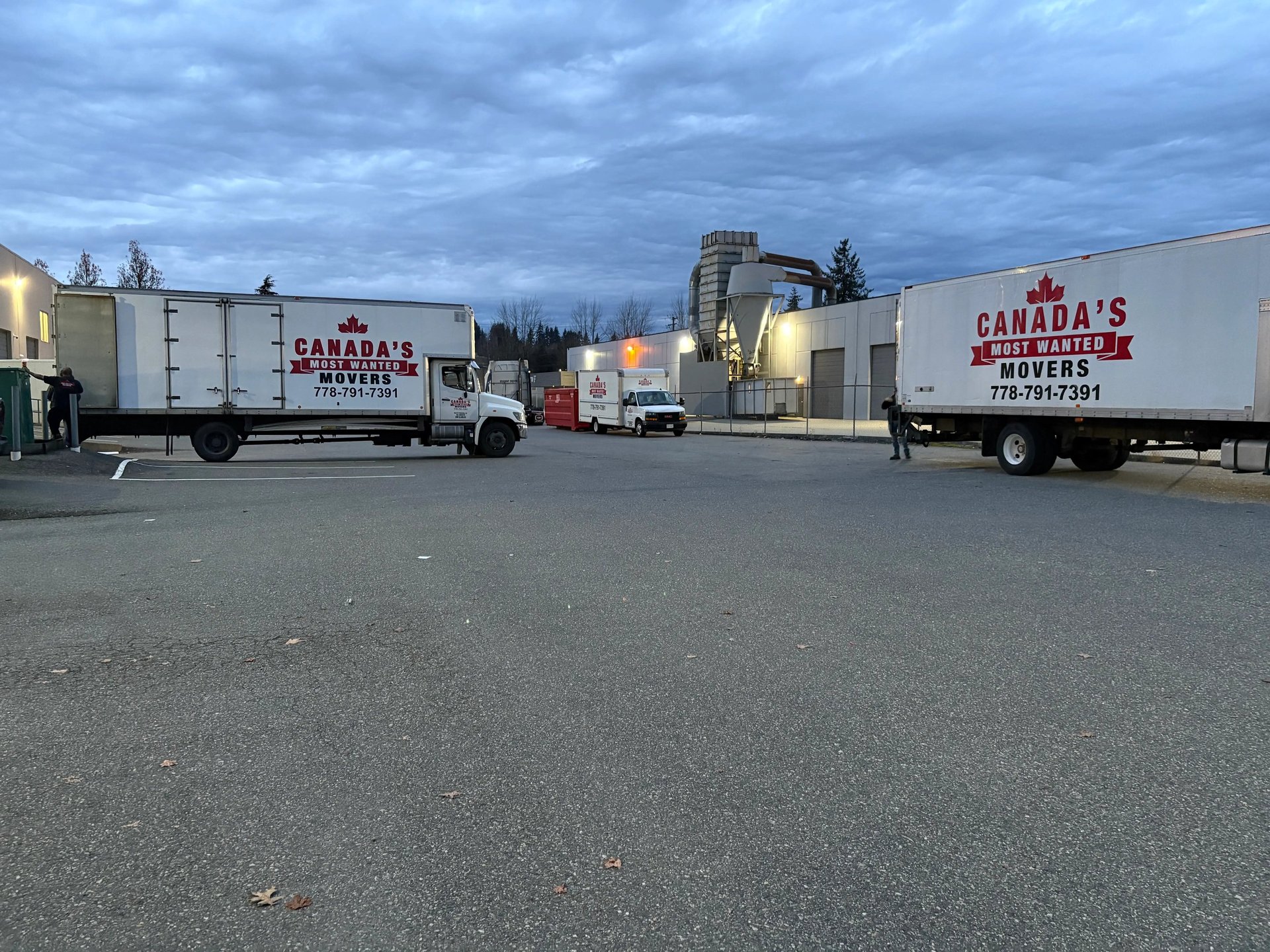 Canada’s Most Wanted Movers trucks parked at an industrial warehouse in Vancouver before a scheduled move.