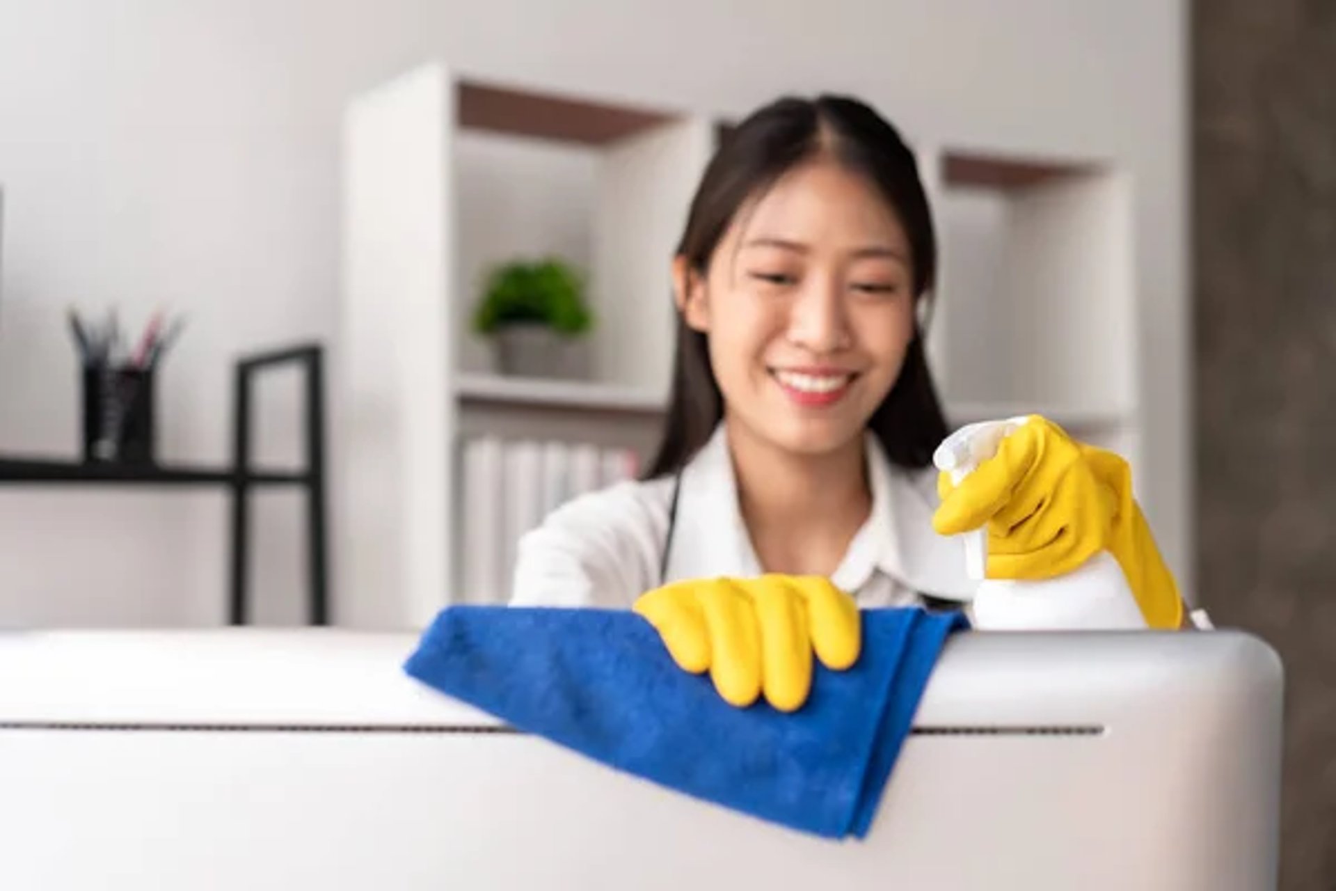 person in blue gloves holding white textile