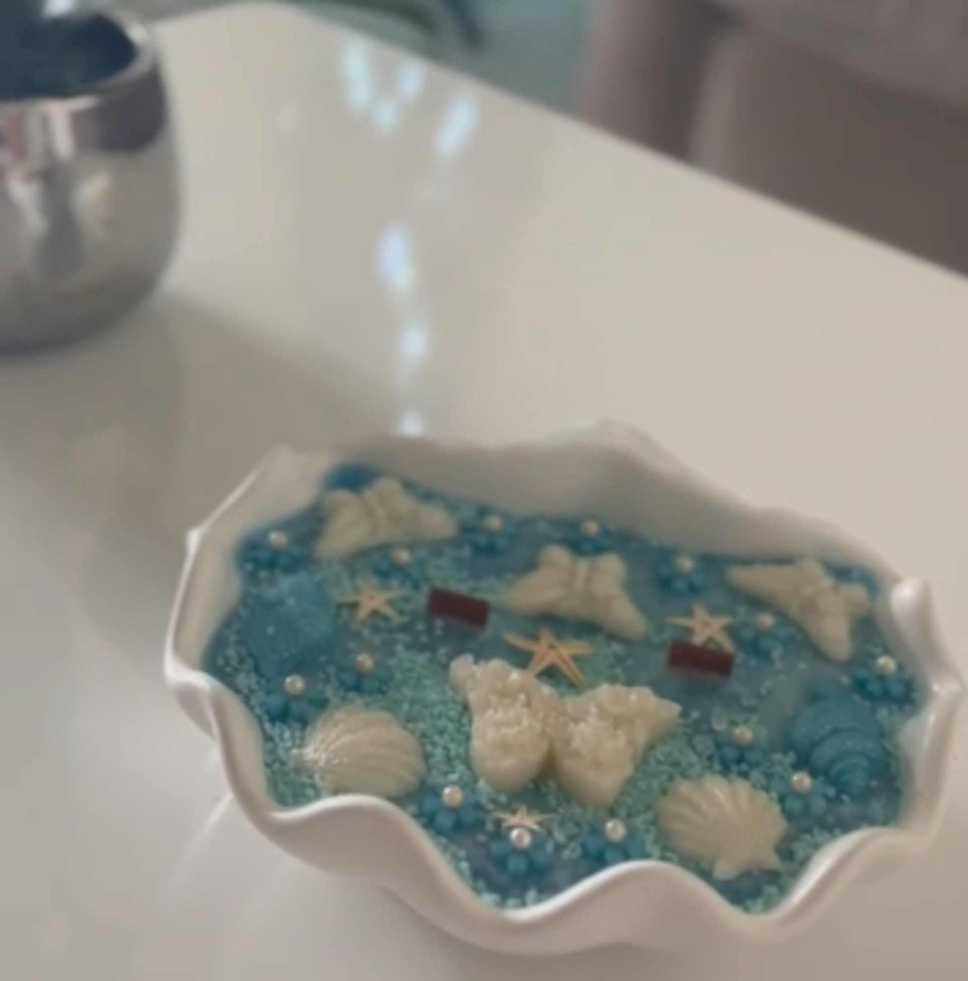 Exquisite decorative scented candle with blue hand poured wax, decorated with shells and butterflies