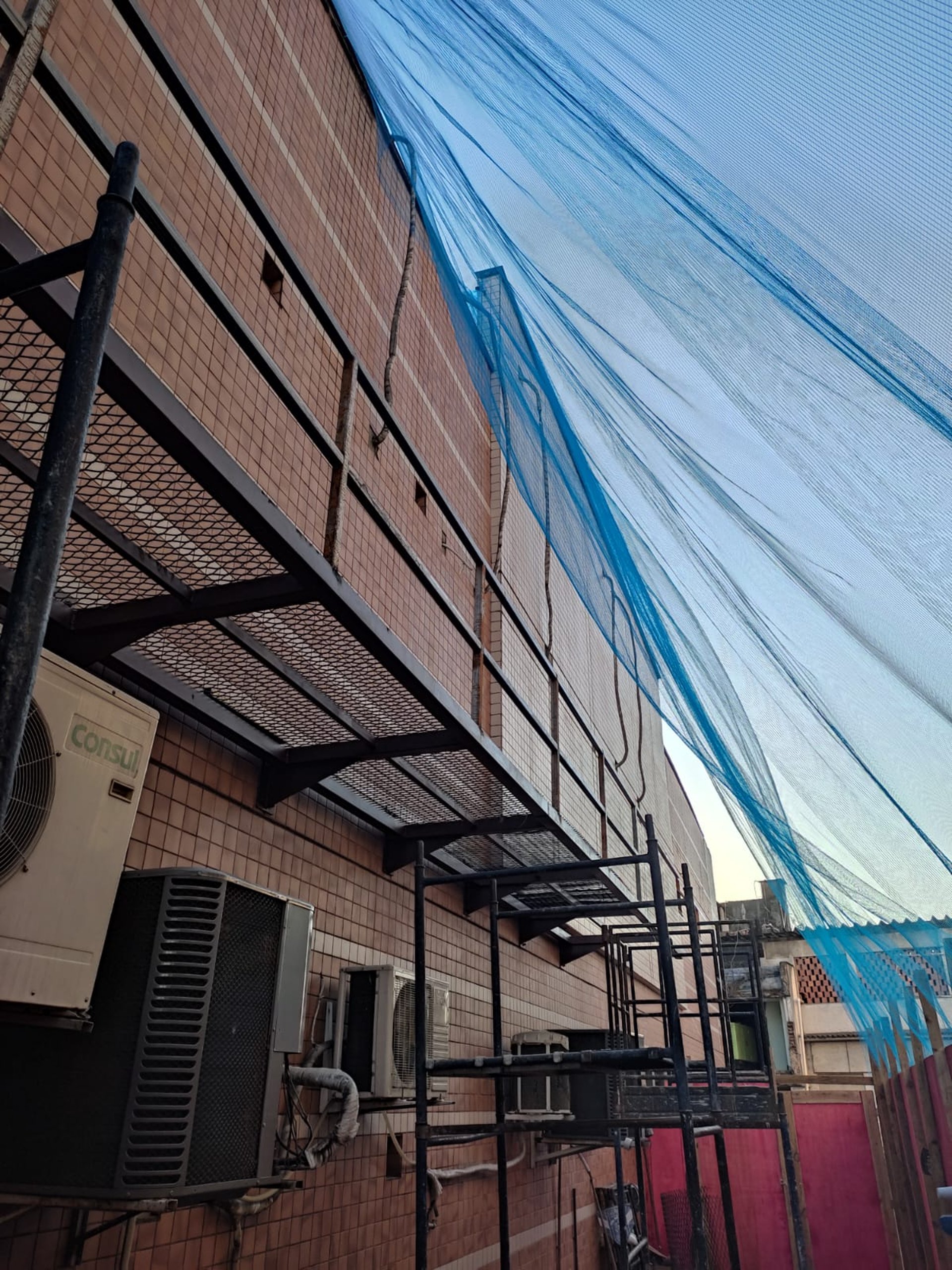 an abstract photo of a curved building with a blue sky in the background