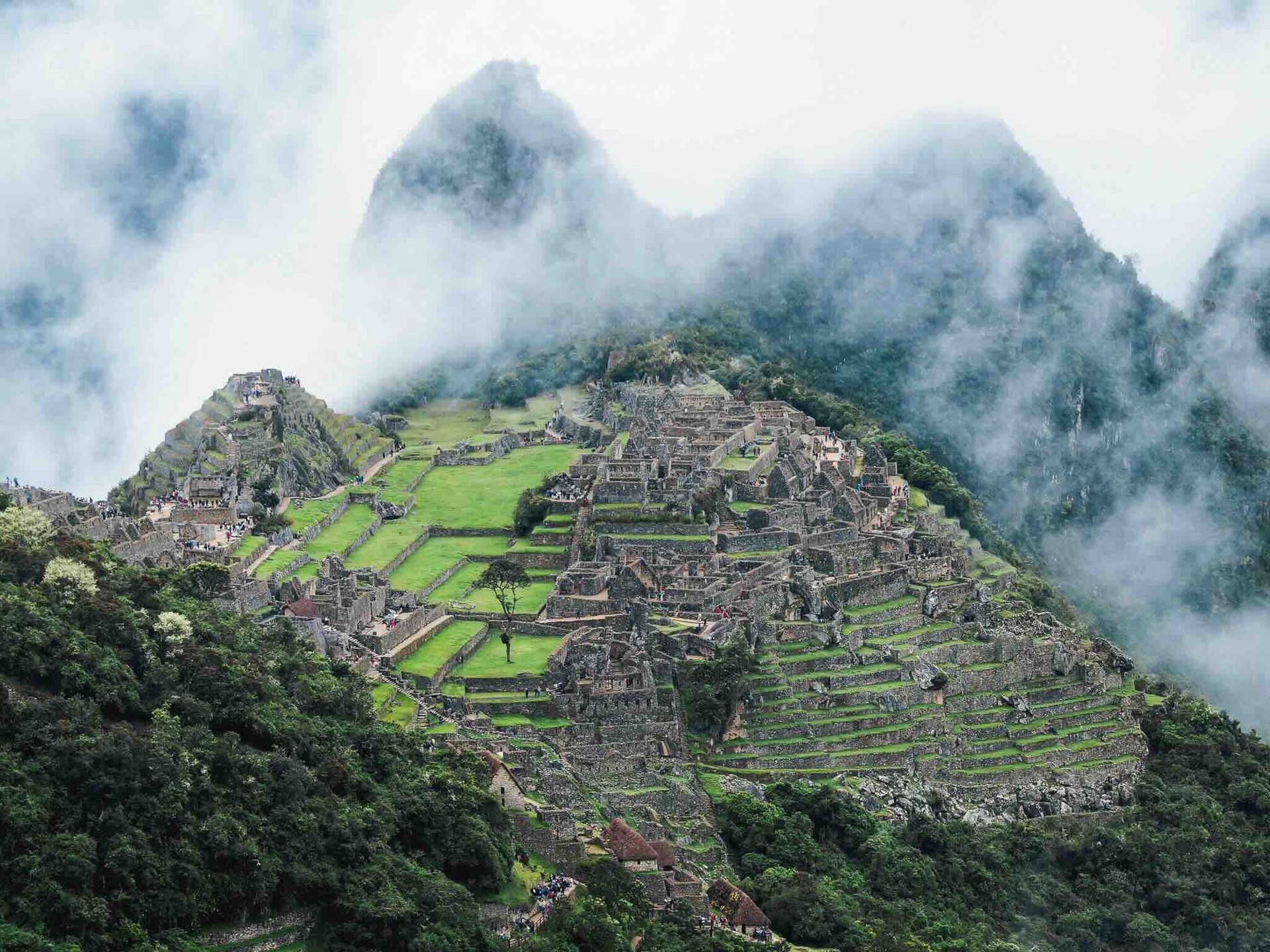 Mystical view of Machu Picchu surrounded by clouds, nestled in the mountains of Peru.
