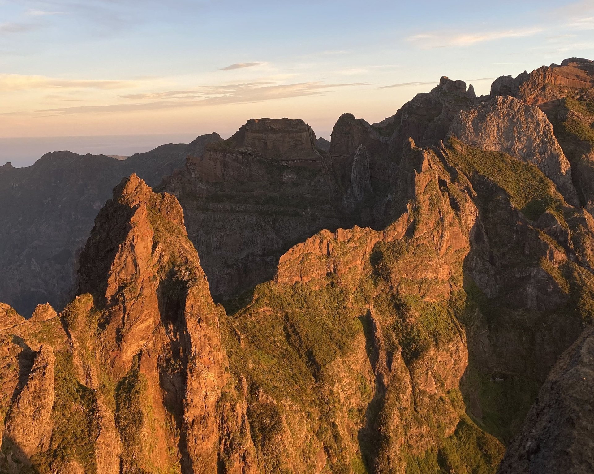 At sunrise, the view from the Pico do Arieiro to Pico Ruivo hike offers stunning vistas of the rugged peaks.
