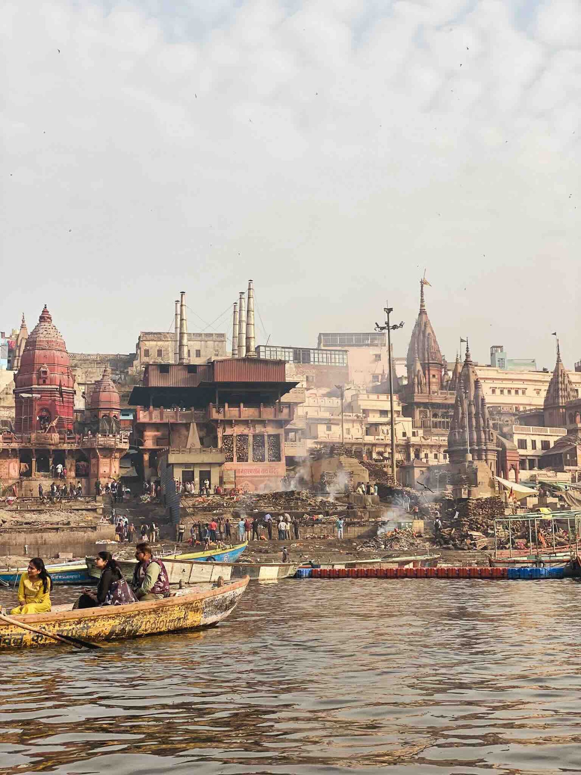 Traditional Hindu cremation ceremony taking place at Manikarnika Ghat in Varanasi, on the banks of the sacred Ganges River.