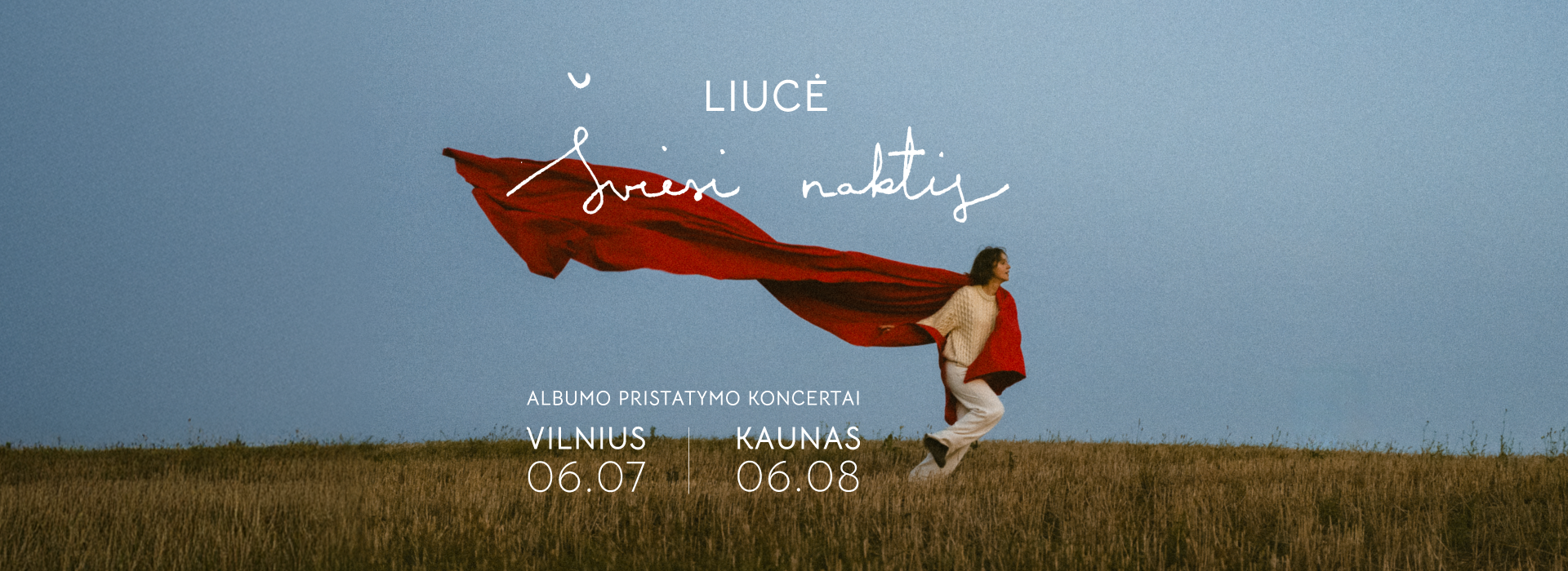 Artist Liucė resting against piano
