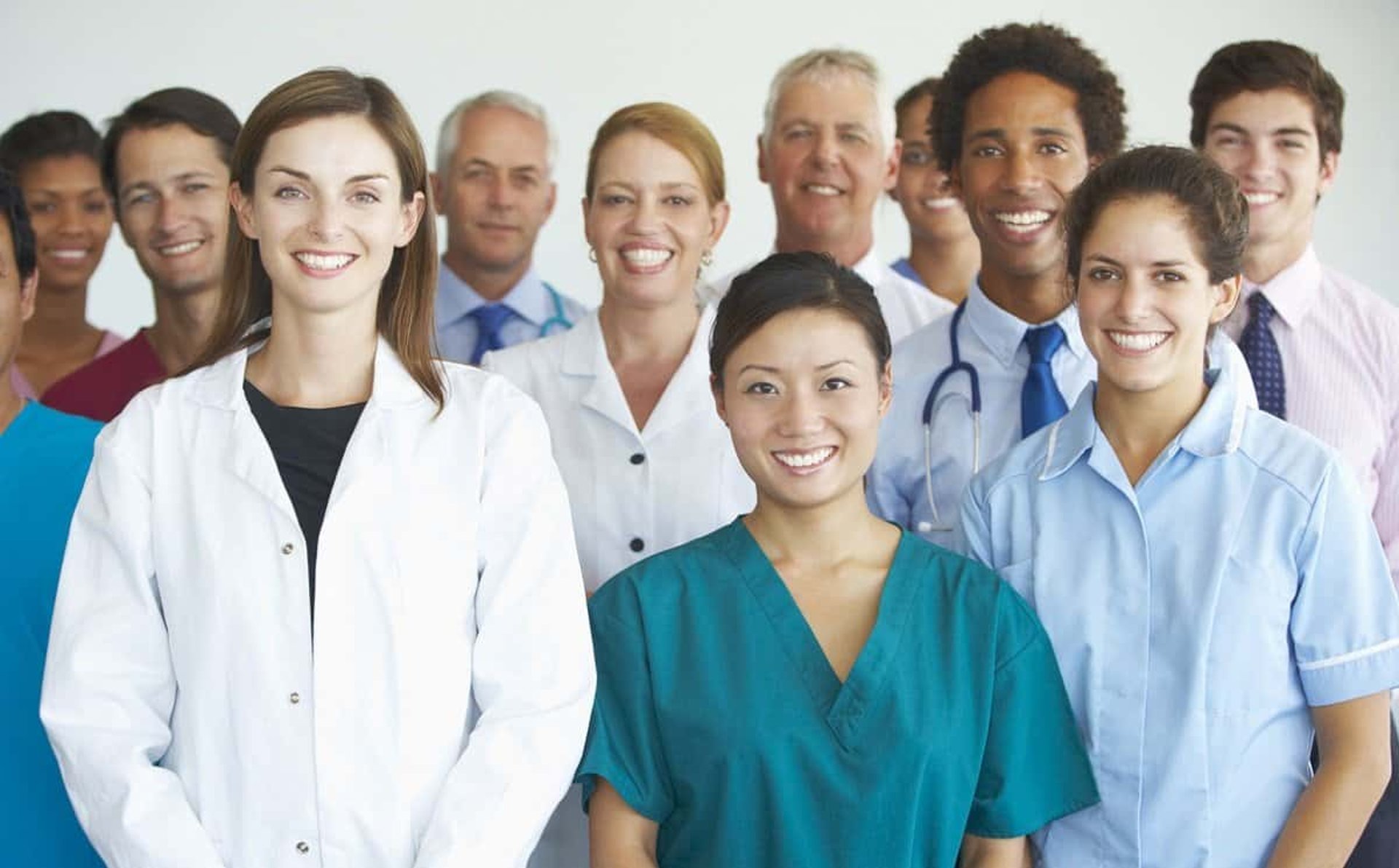 group of people sitting on bench near trees duting daytime