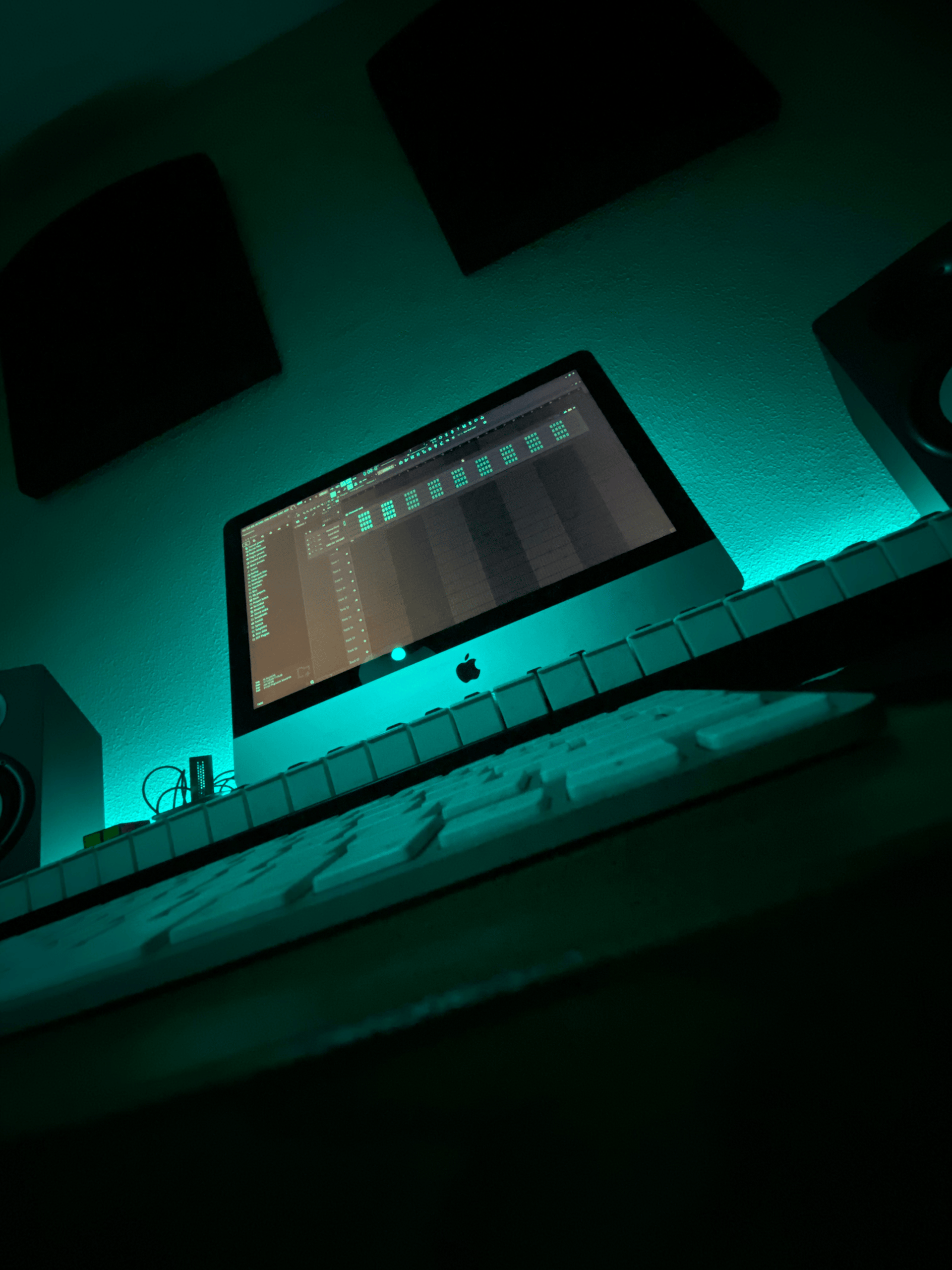 a room with a desk and speakers
