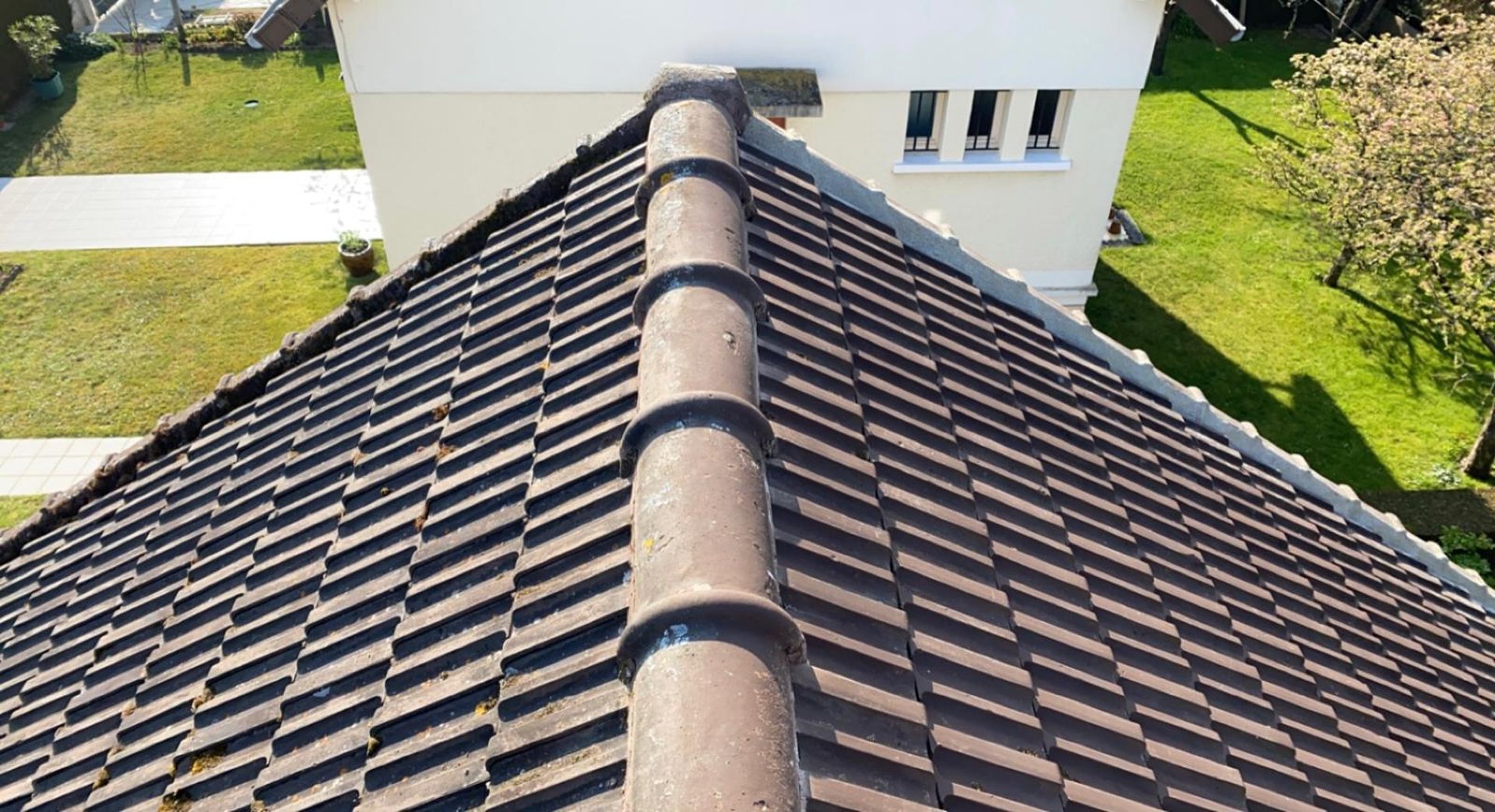 a man on a roof working with a rope