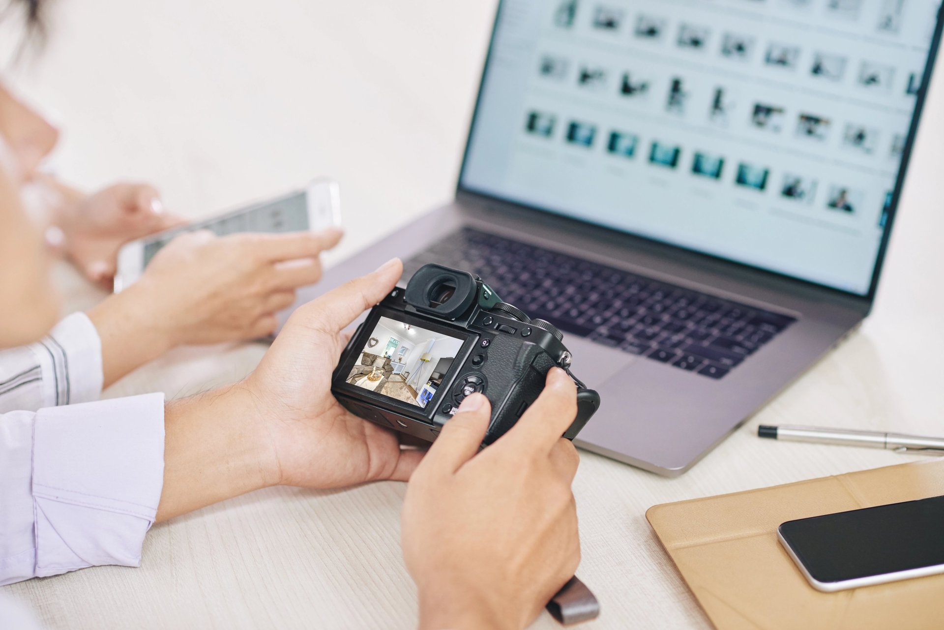 a woman sitting at a desk on a cell phone