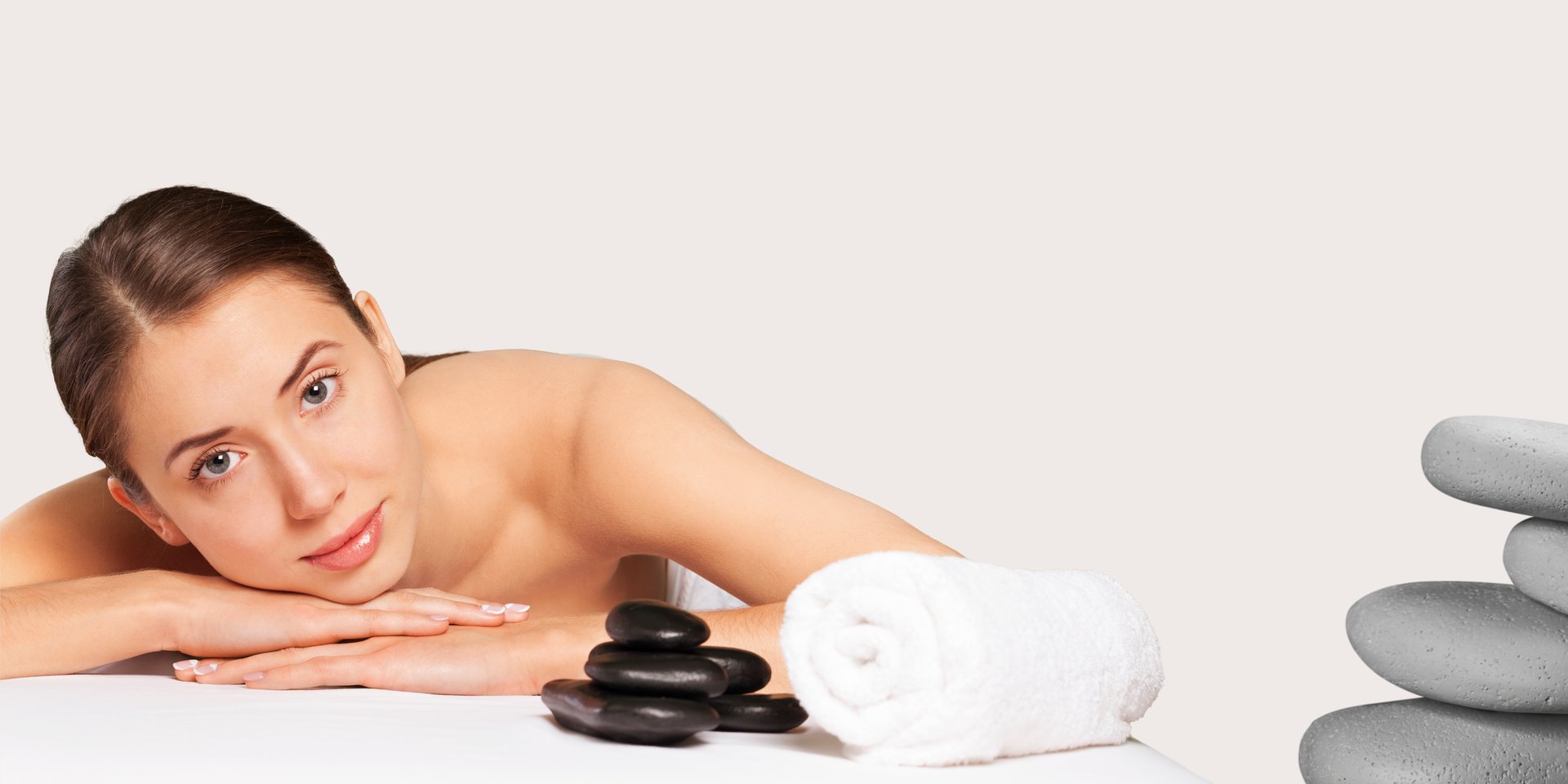 white plastic pump bottle beside pink tulips and gray towel