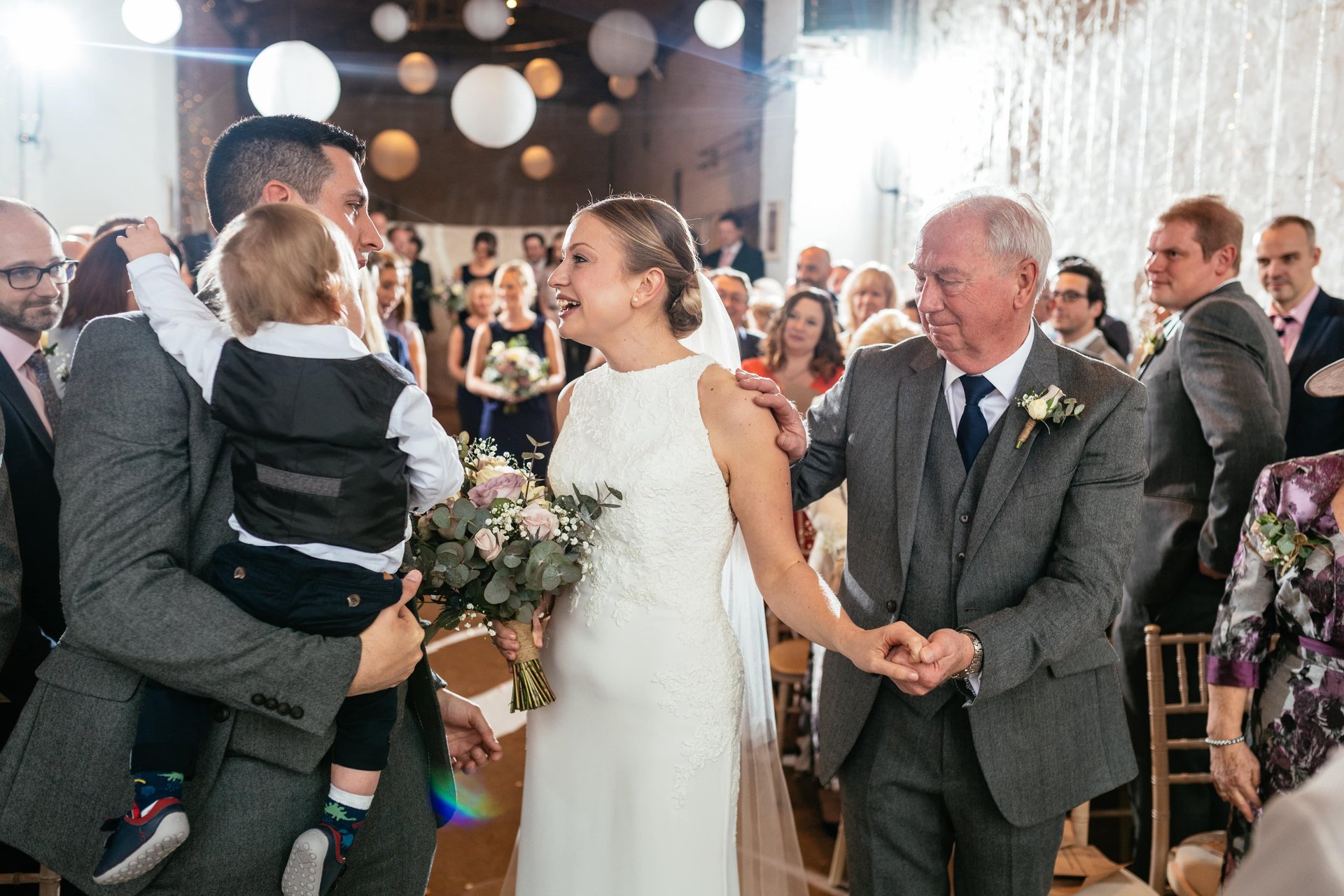 Bride smiling during wedding ceremony at Rosedew Farm, South Wales, captured in natural candid style by Owen Mathias